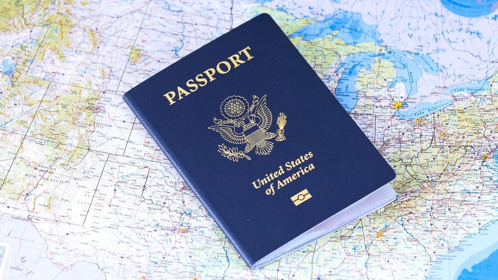 US passport resting on a colorful map showing North America and the Great Lakes region.