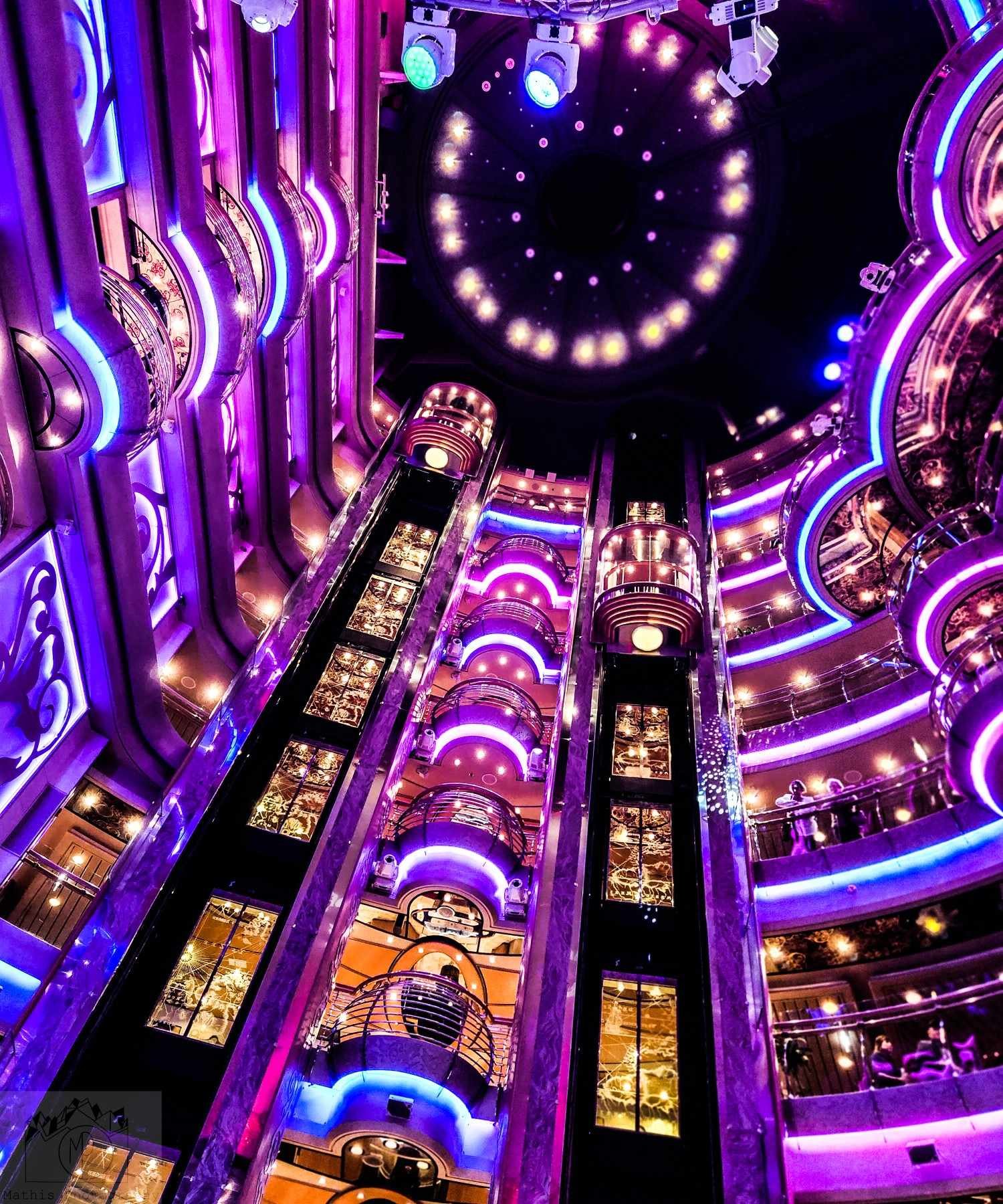 # Cruise ship atrium with purple neon lighting and multiple decks