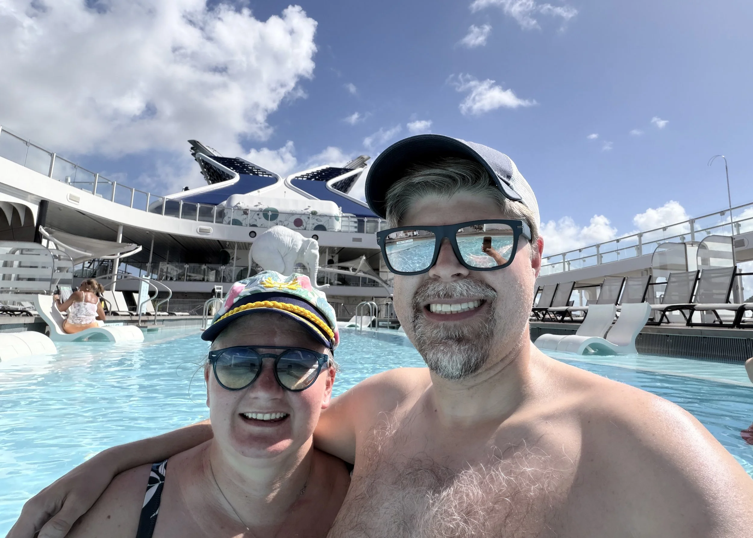 Two guests enjoying poolside fun on cruise ship