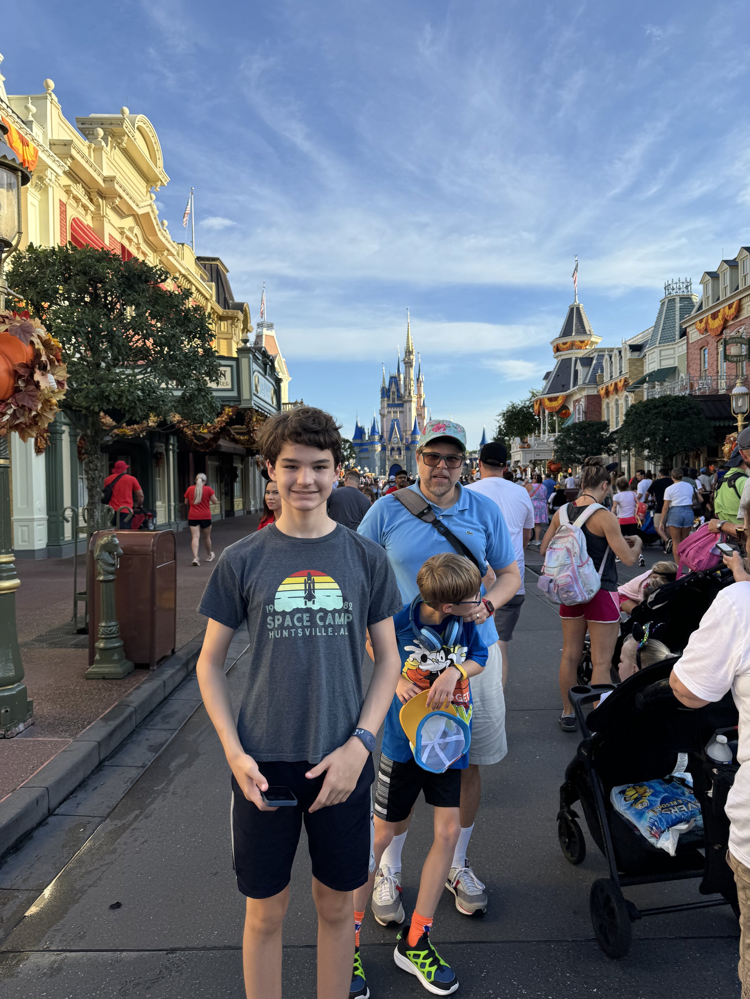 Family at Disney's Magic Kingdom with Cinderella Castle background