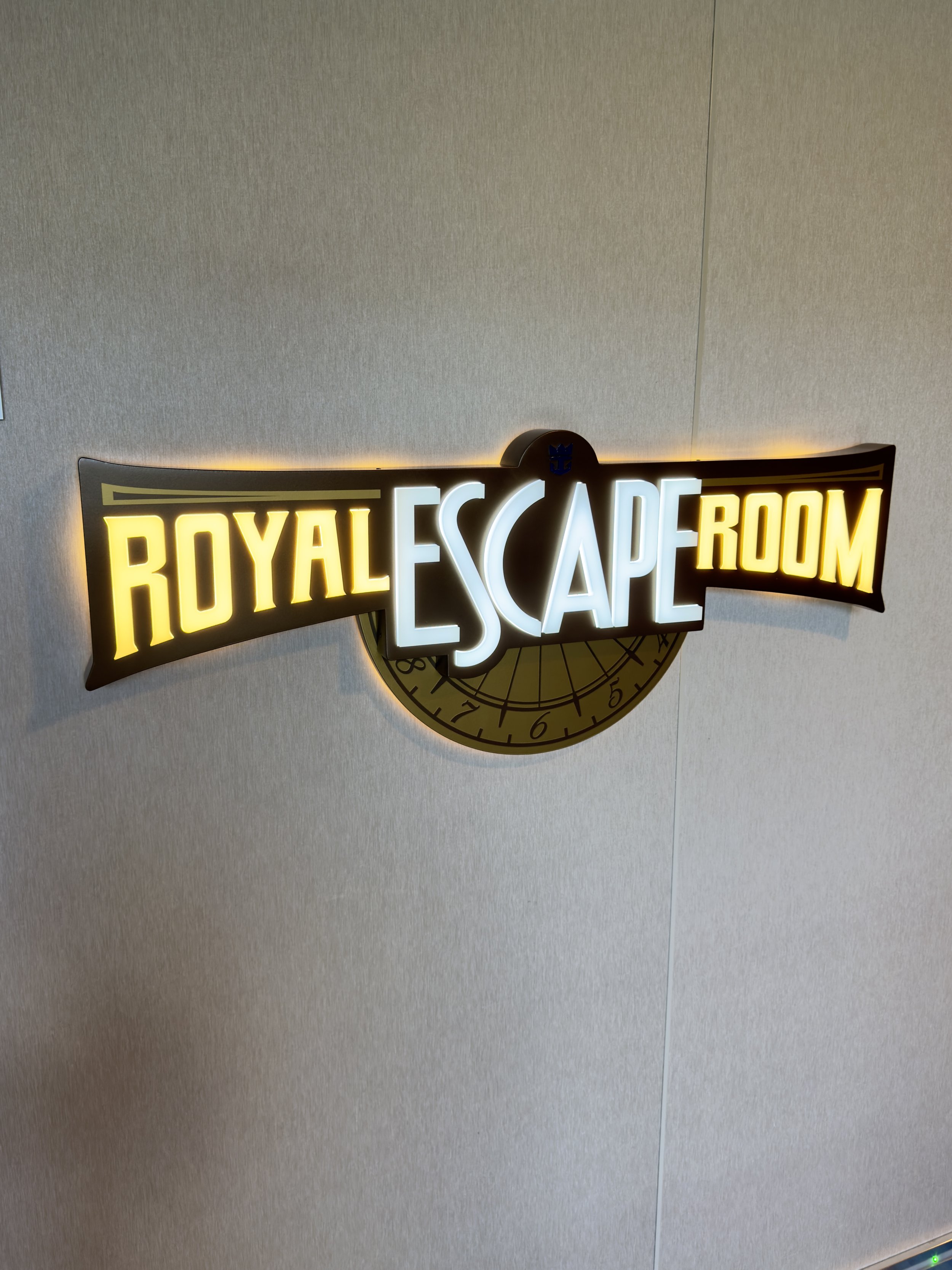 Royal Escape Room illuminated neon sign on wall