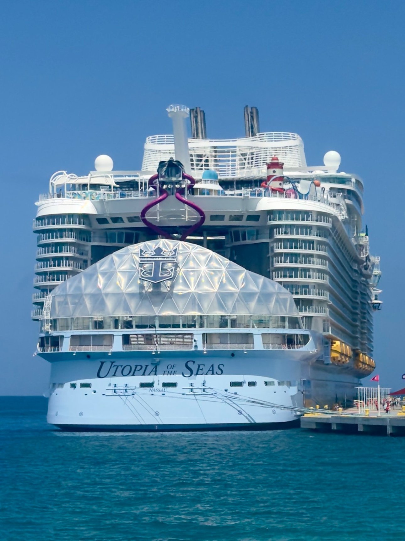 Utopia of the Seas cruise ship docked at tropical port