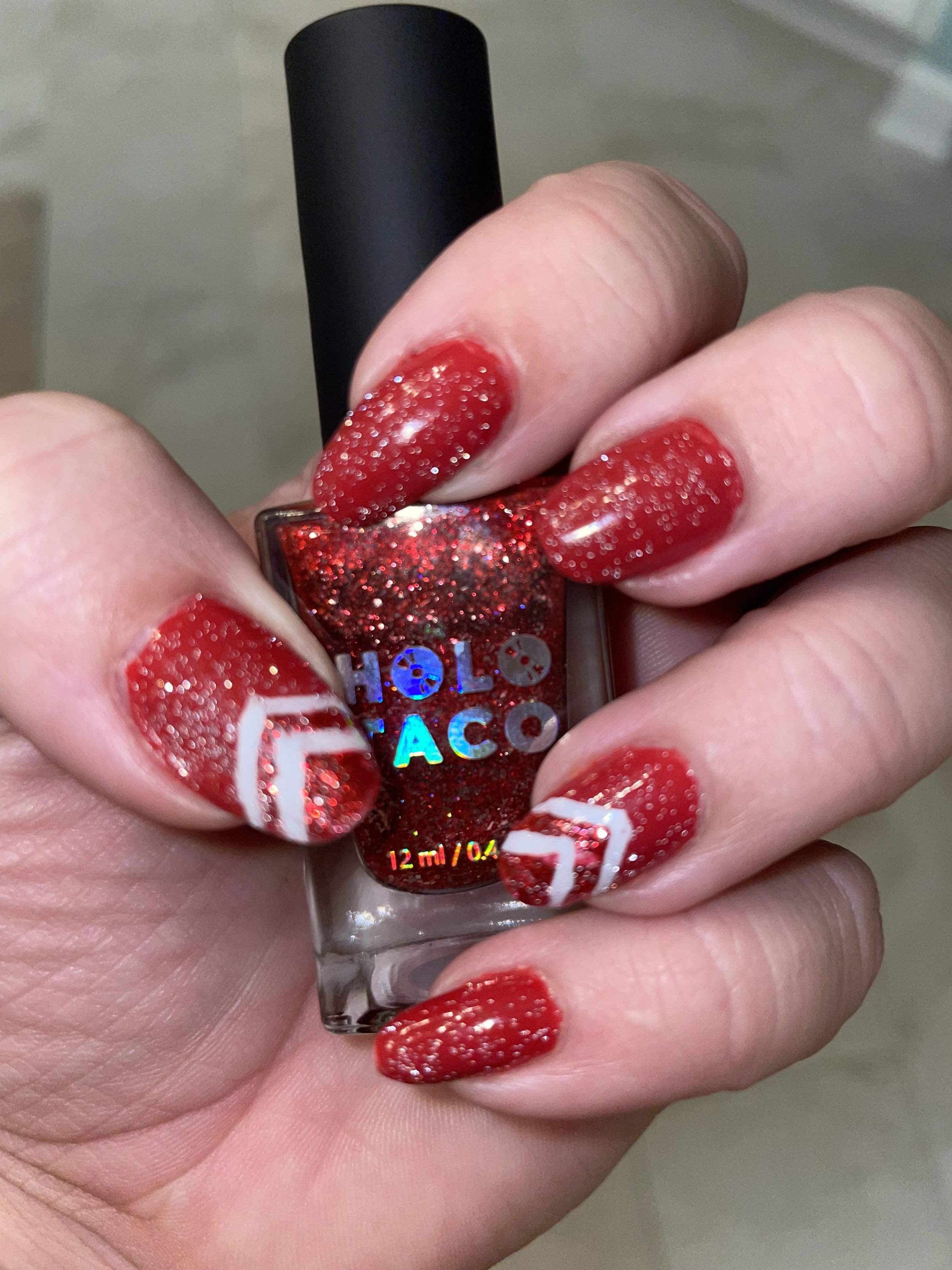 Red glitter nail polish with white cruise ship nail art design