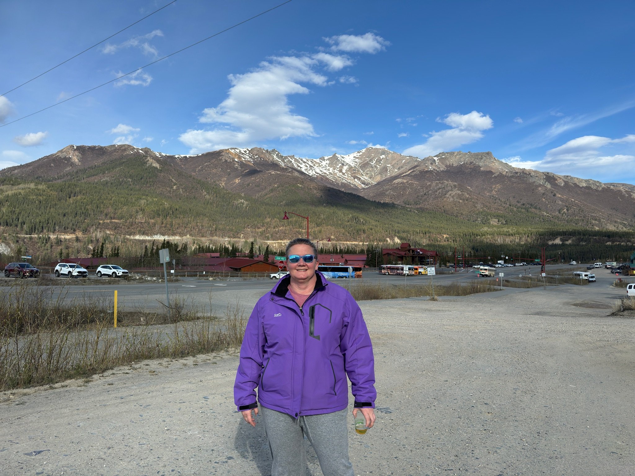 Person in purple jacket at mountain resort parking area