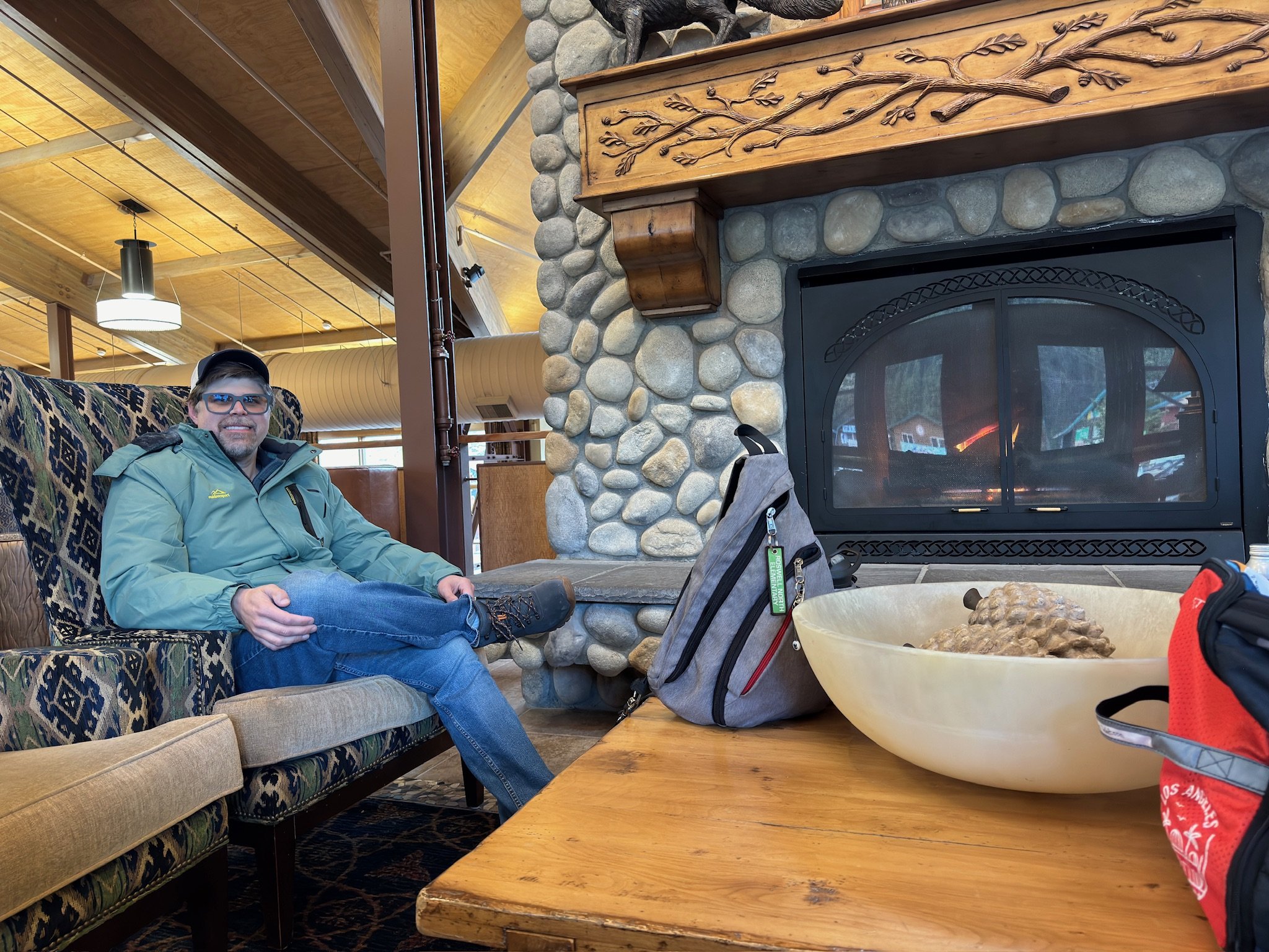 Man relaxing by fireplace in cruise ship lounge area