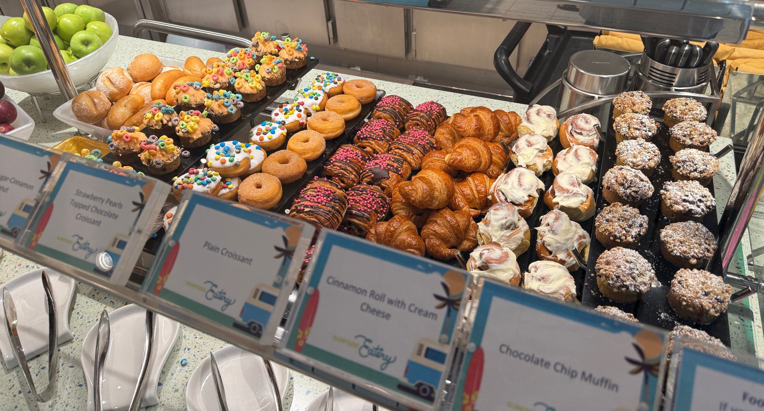 Disney bakery display with donuts, croissants, muffins, pastries