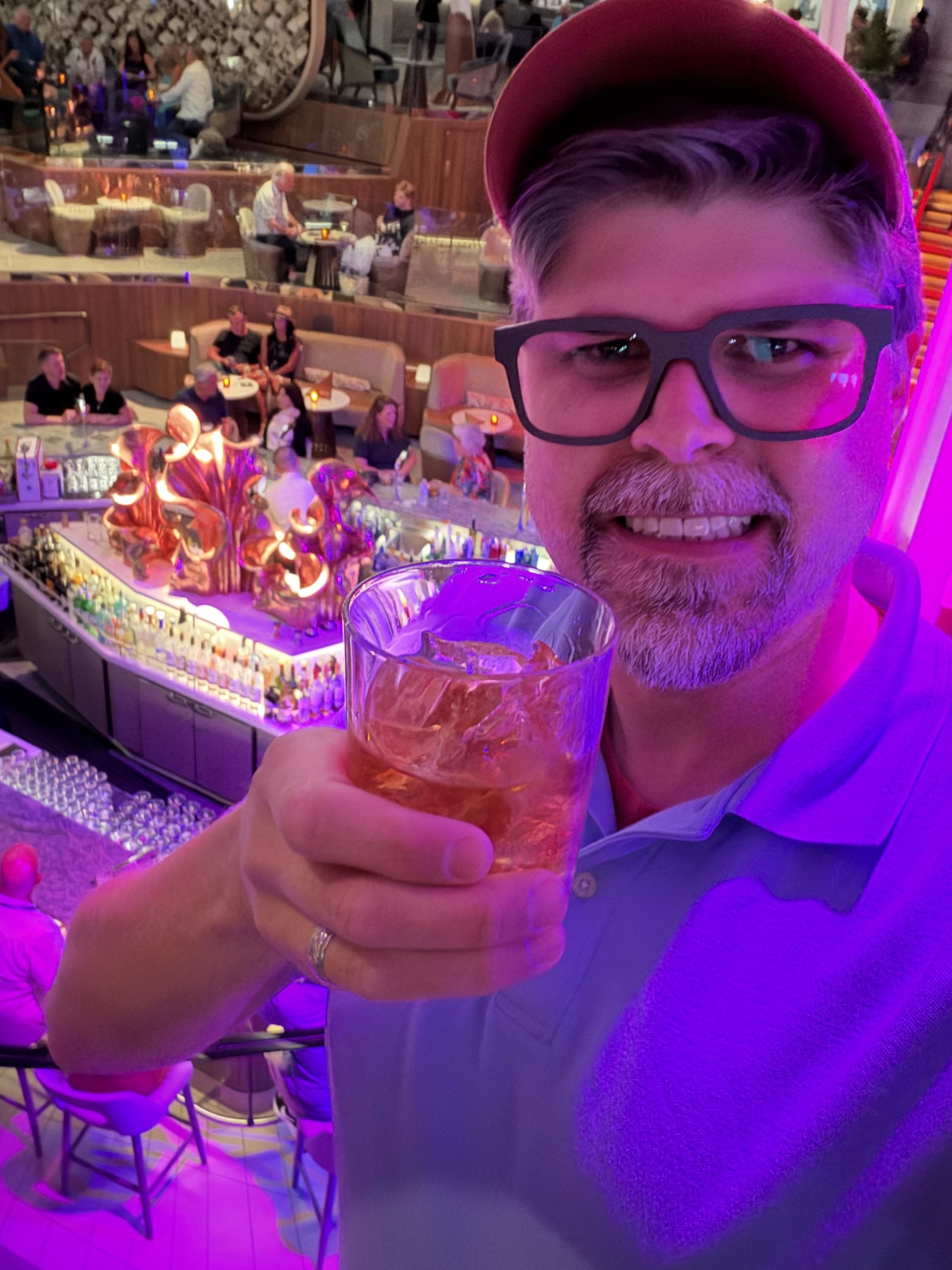 Man holding cocktail on cruise ship balcony