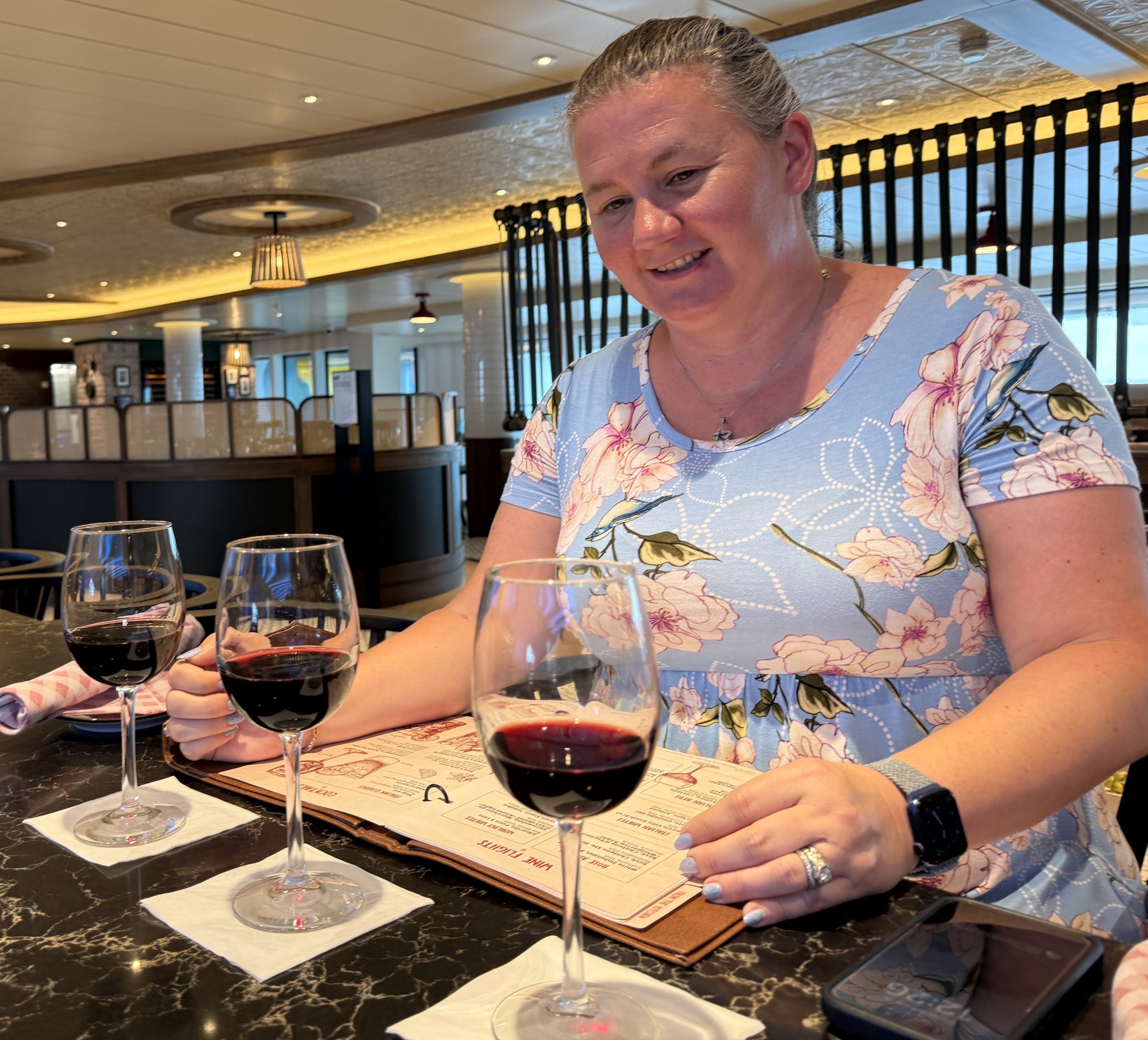Woman enjoying wine tasting in cruise ship dining room