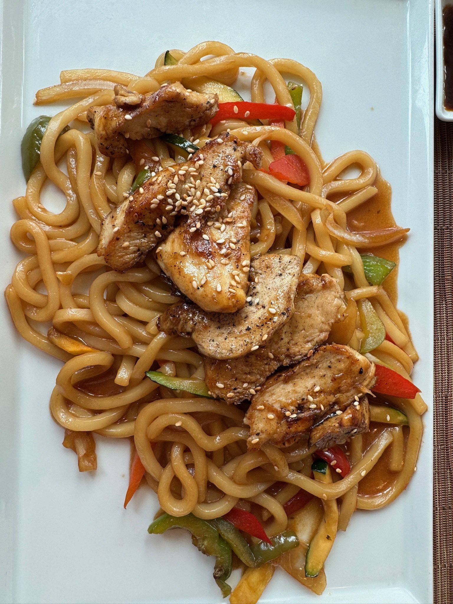 Stir-fried noodles with sliced meat and sesame seeds