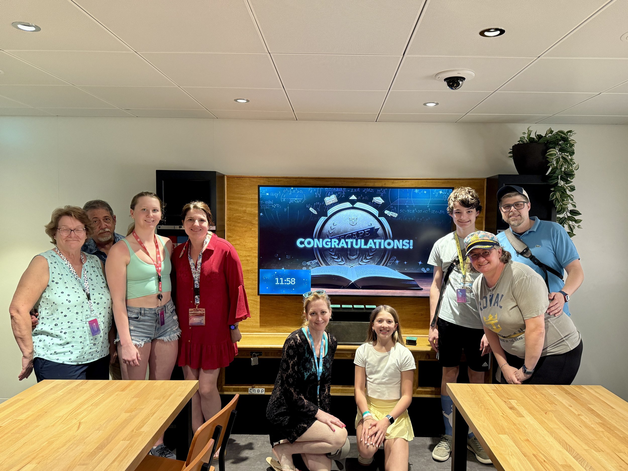 Group celebrates onboard with congratulations screen display