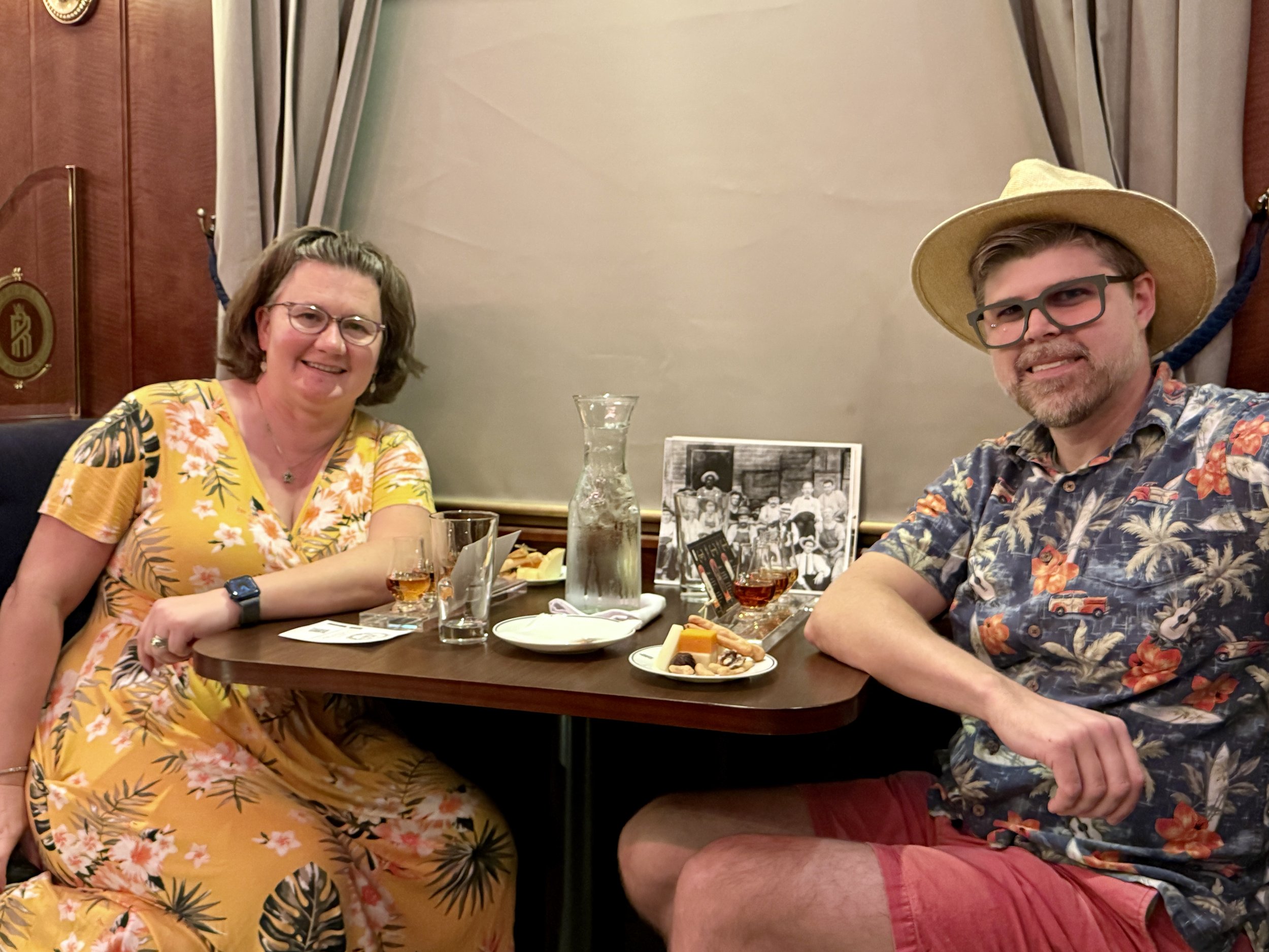 Two people dining together in formal ship restaurant with tropical shirts