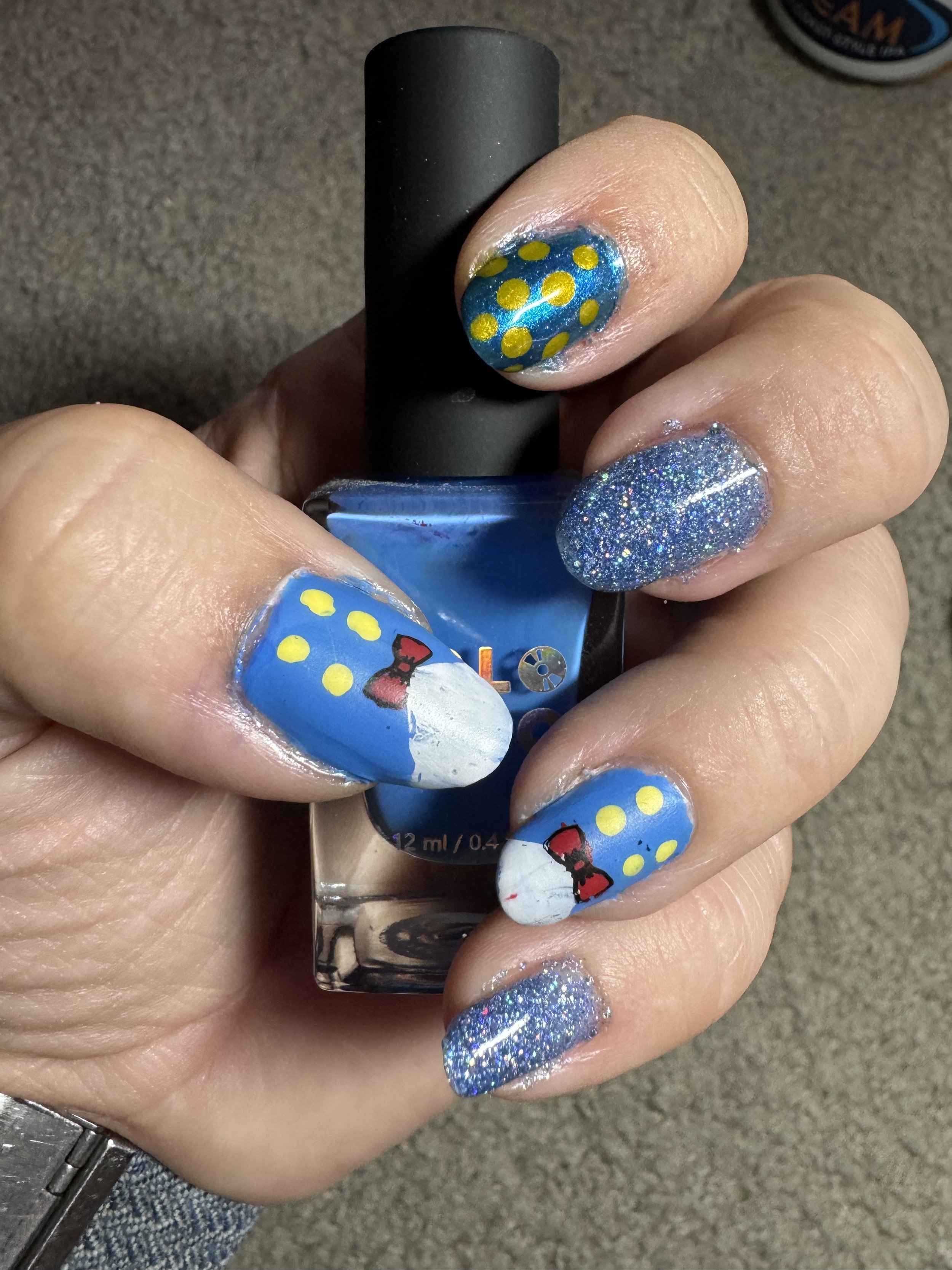 Blue nail polish with cruise ship and ocean themed designs