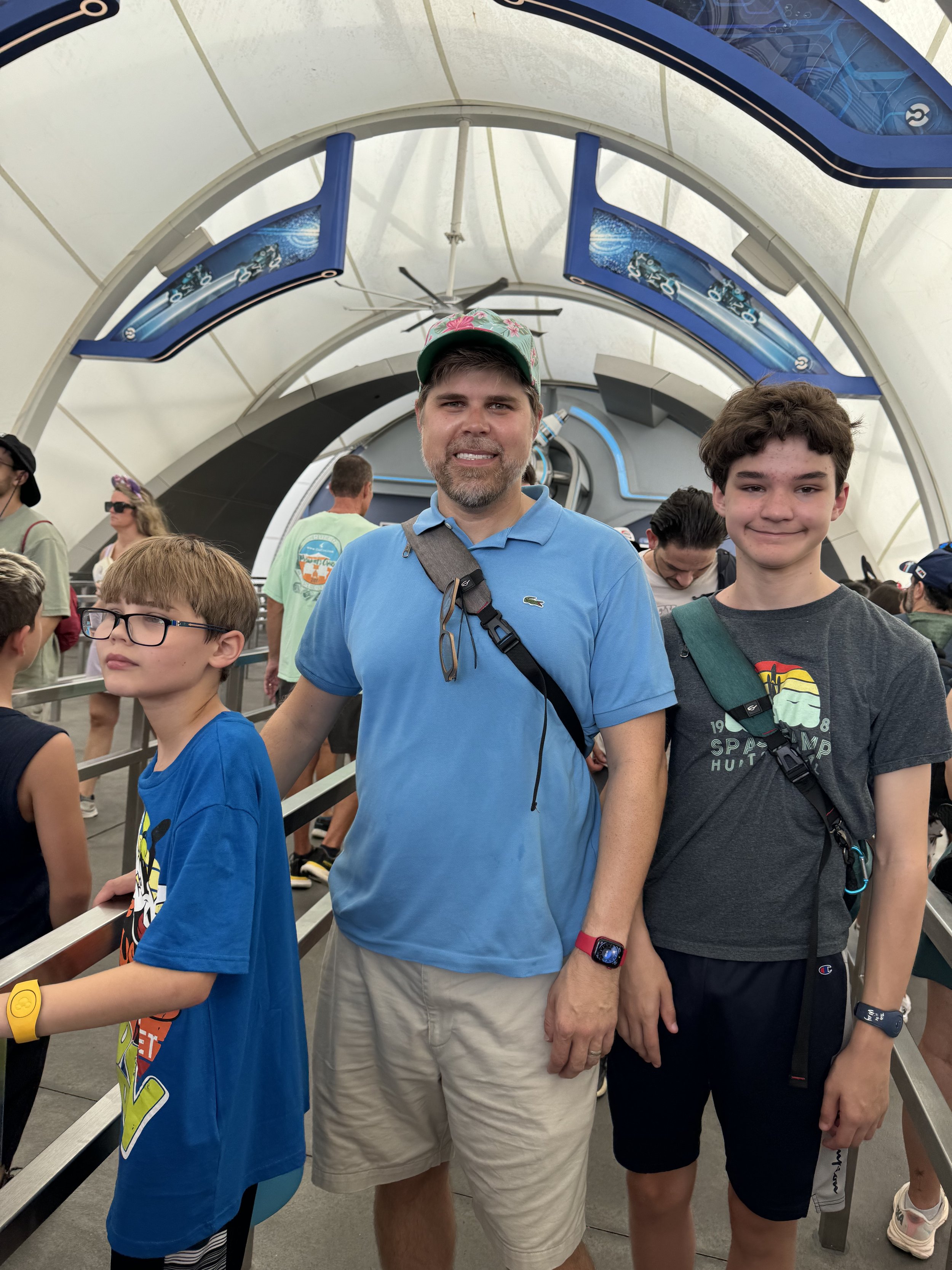 Man and two boys inside cruise ship corridor