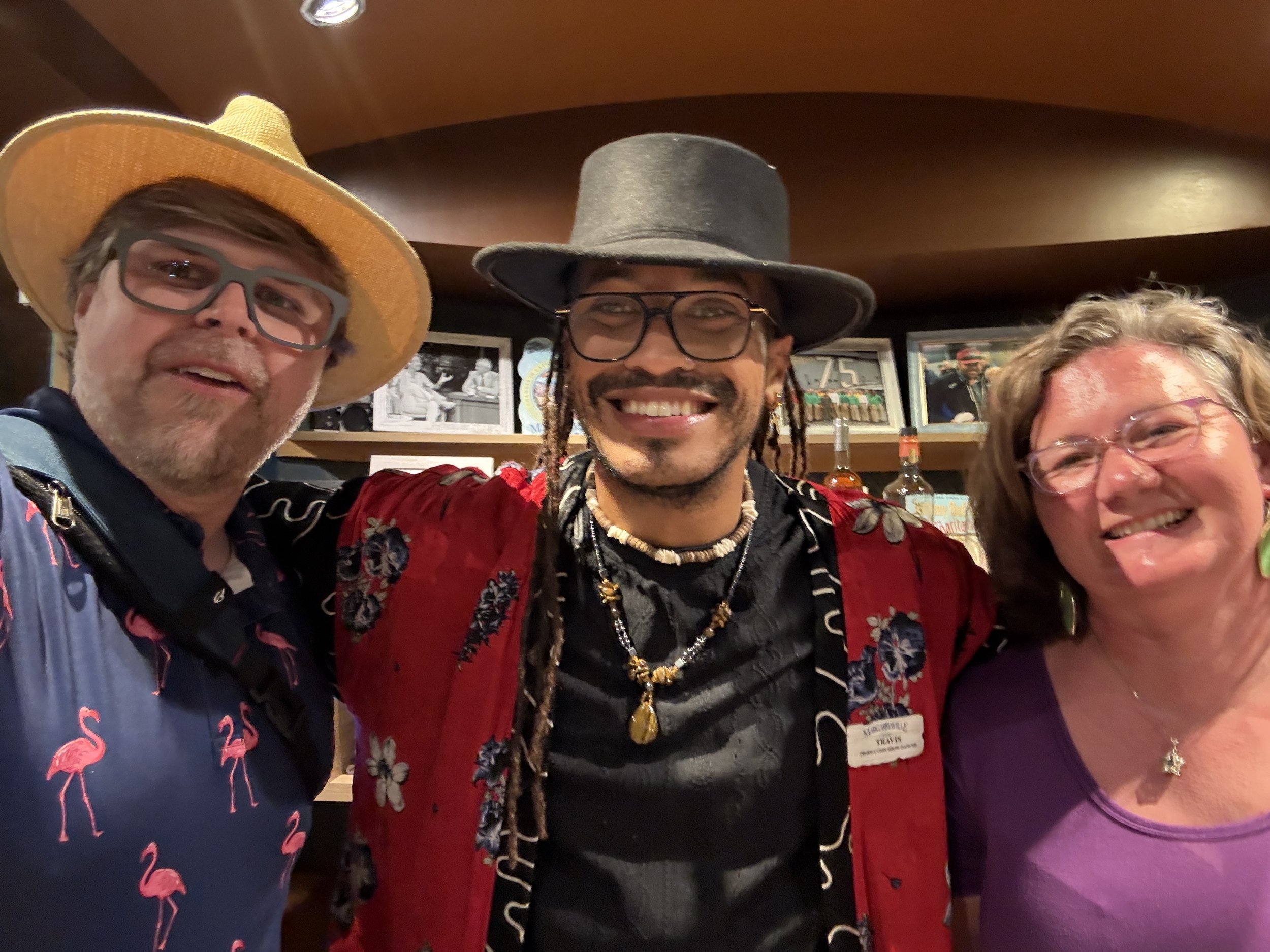 Three people in Western-themed costumes at cruise ship event