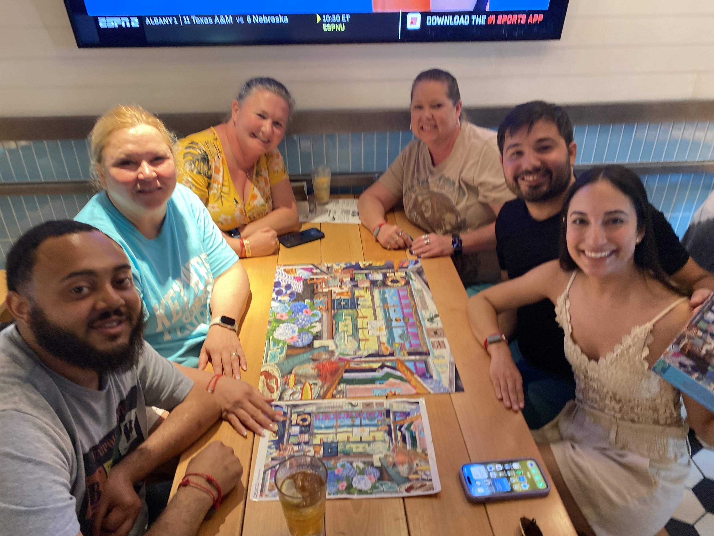 Group enjoying board games at sports bar during cruise