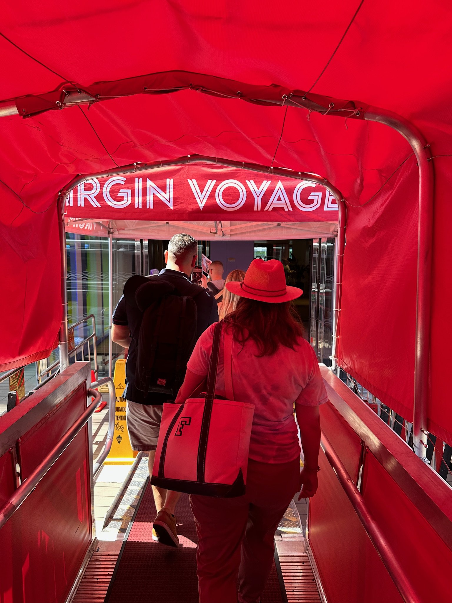 Virgin Voyage cruise ship interior hallway entrance with passengers boarding