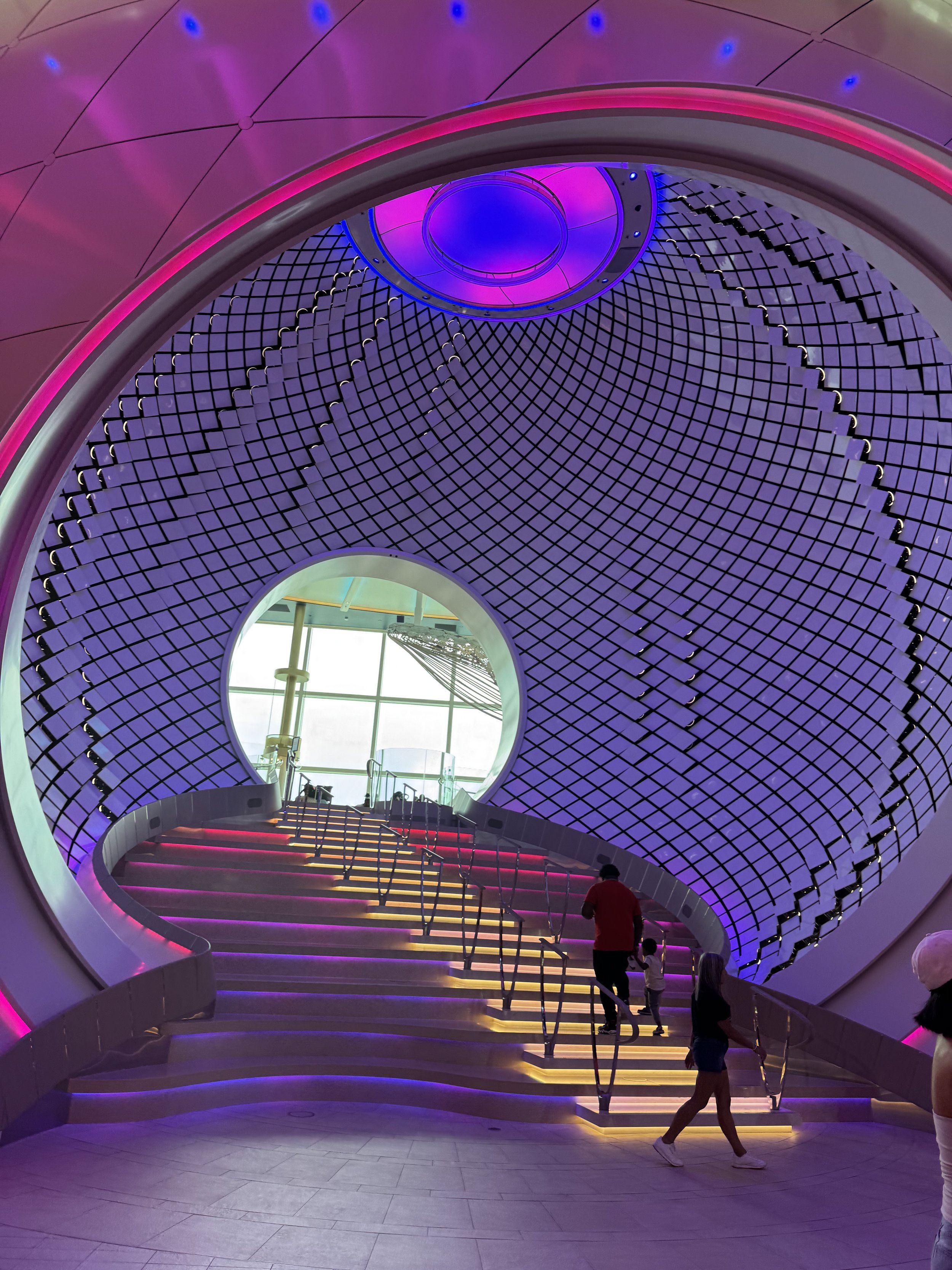 Futuristic purple lit tunnel staircase with eye-shaped opening