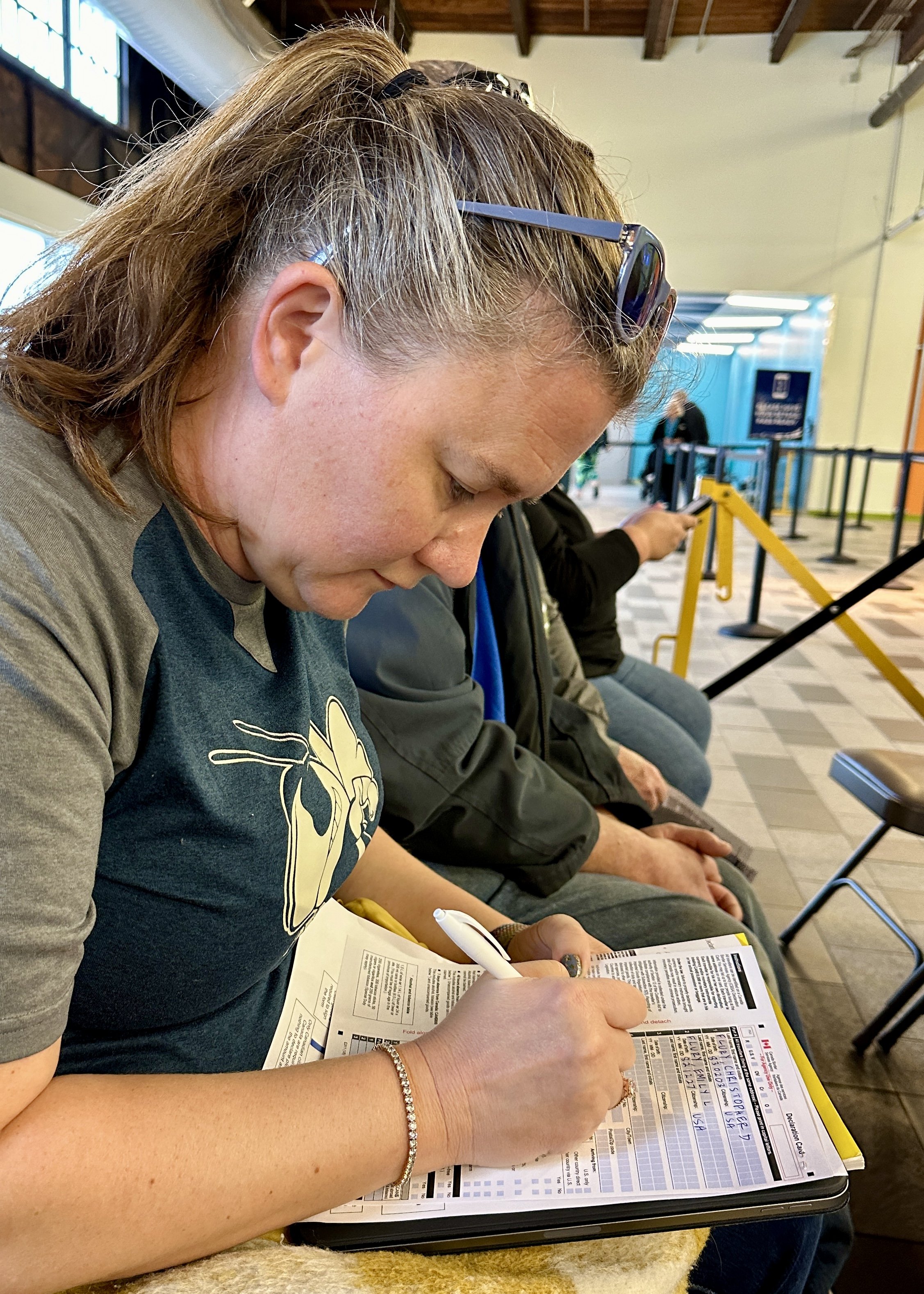 Woman filling out ballot at polling location indoors