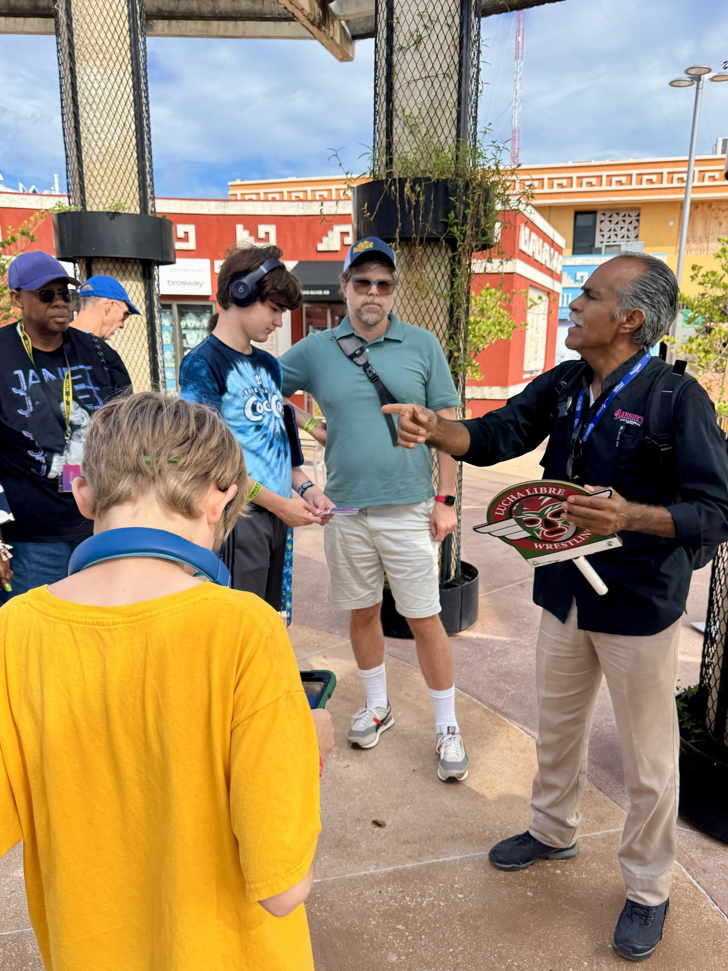Tour guide speaking to group at colorful Caribbean port destination