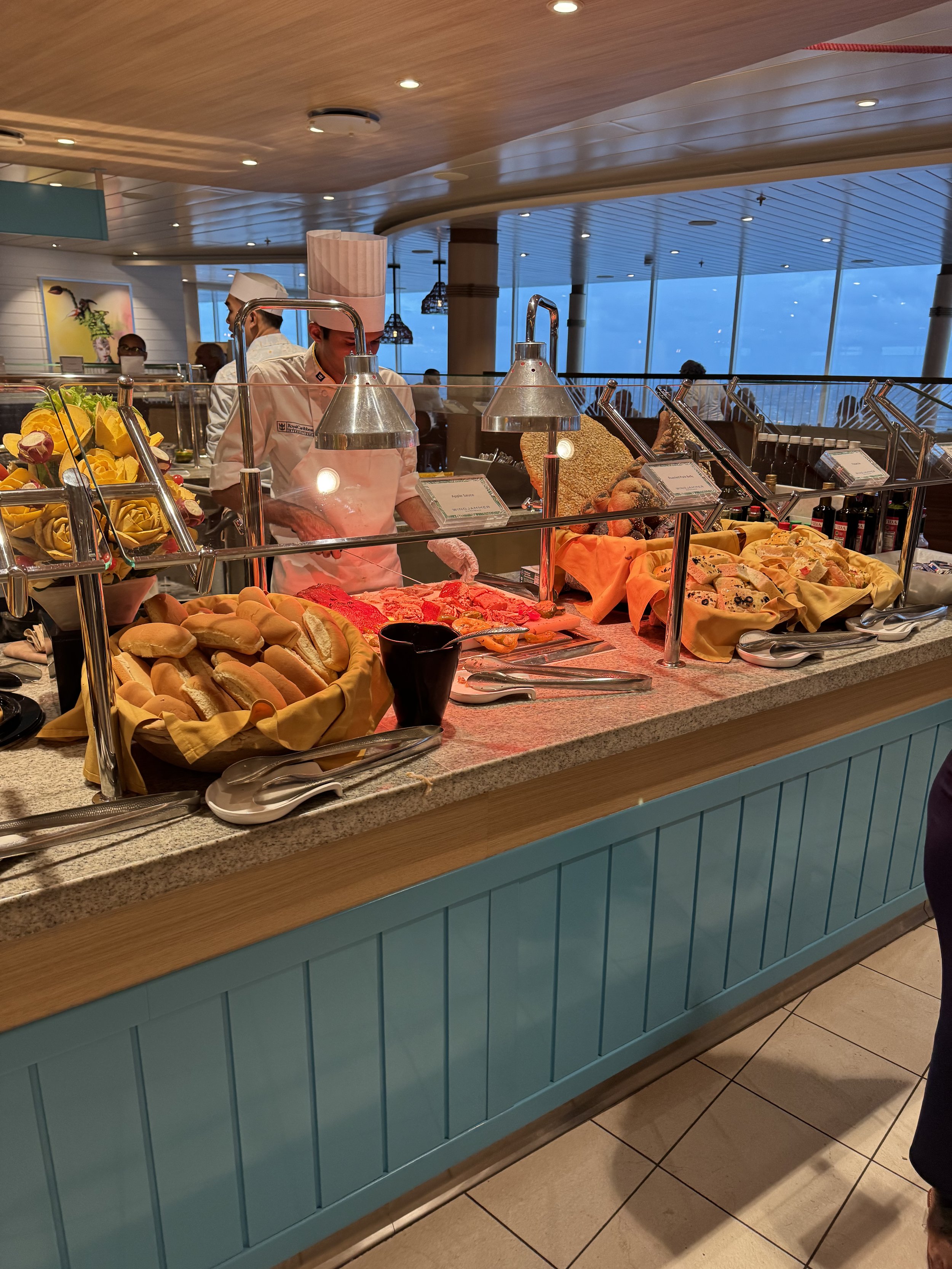 Buffet breakfast display with fresh pastries and breads on cruise ship
