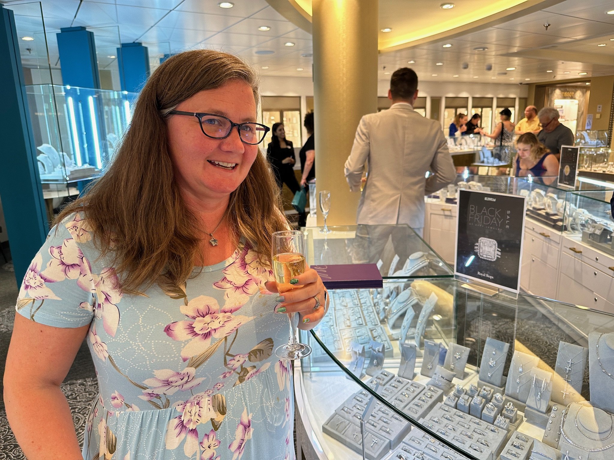 Woman enjoys champagne at jewelry store event