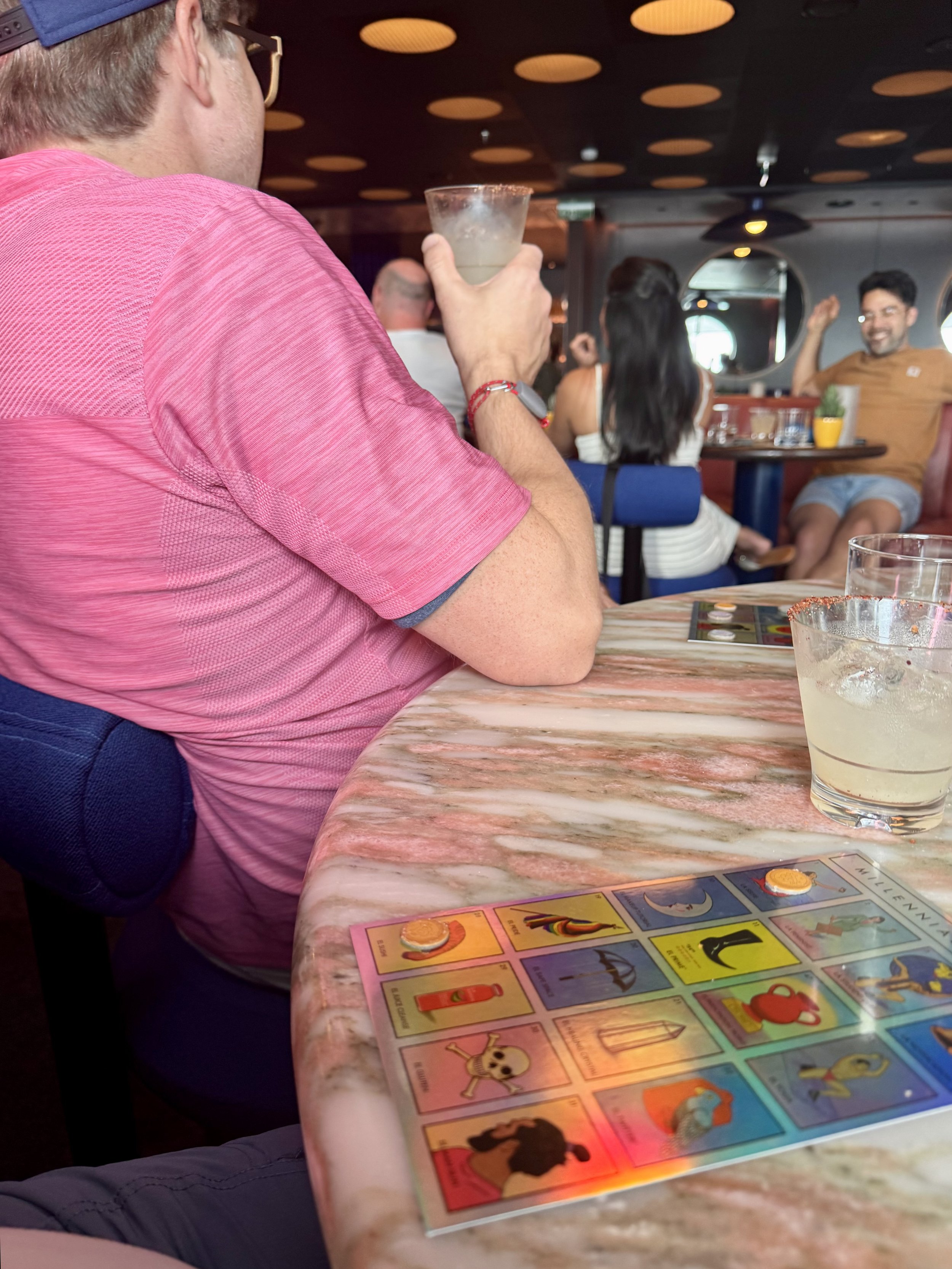 Man viewing Pokemon cards at cruise ship bar gathering