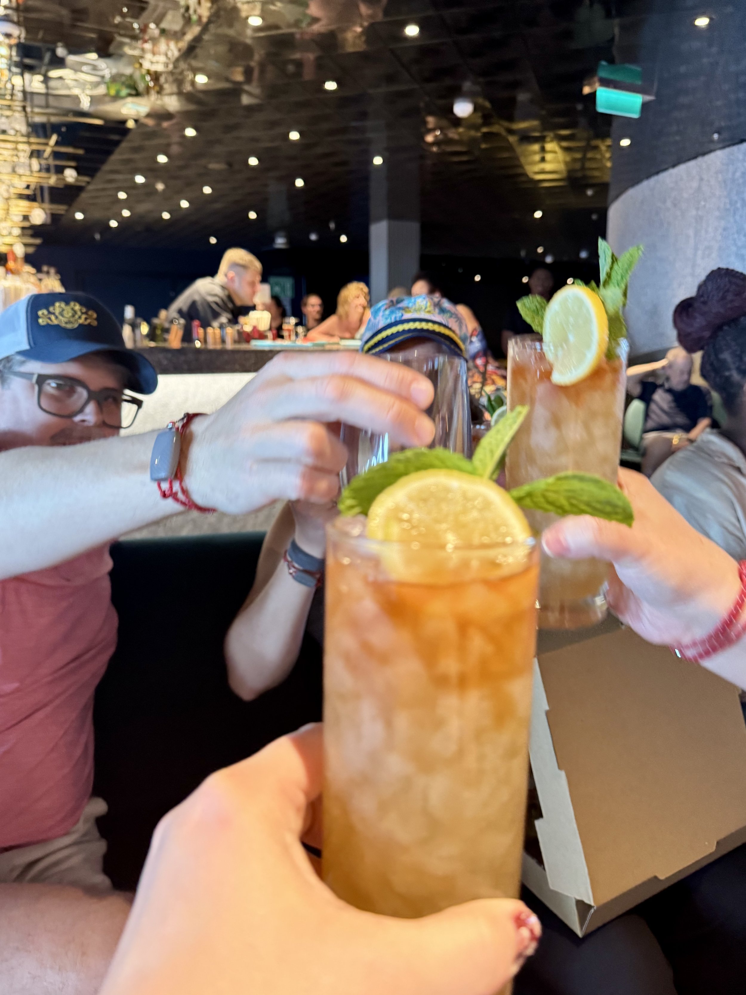 Passengers enjoying tropical cocktails at cruise ship bar