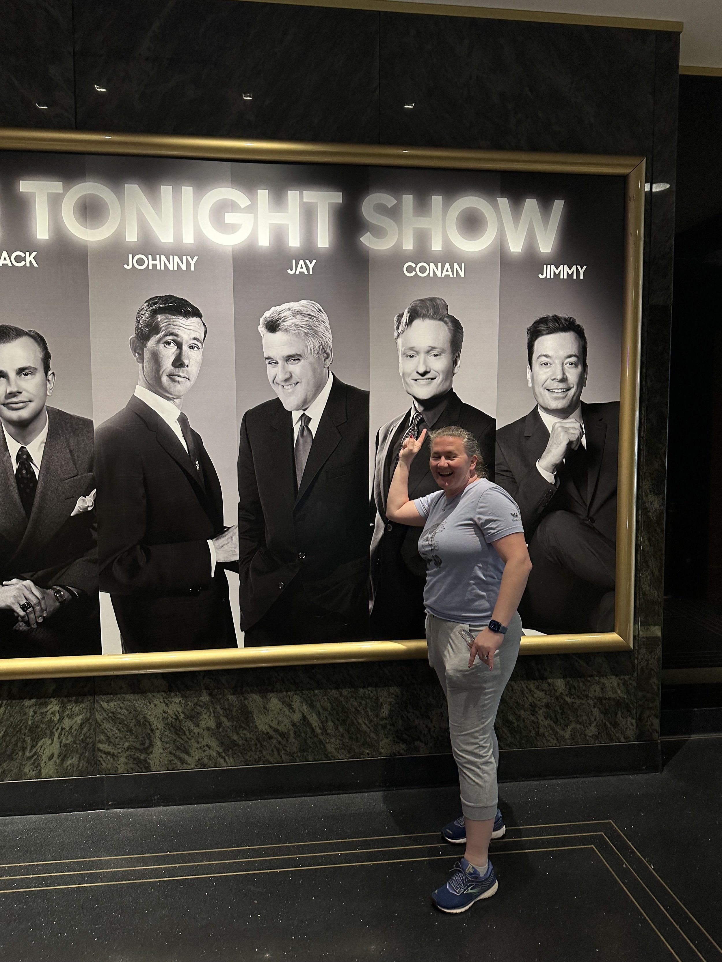 Woman posing with Tonight Show hosts display at NBC Studios