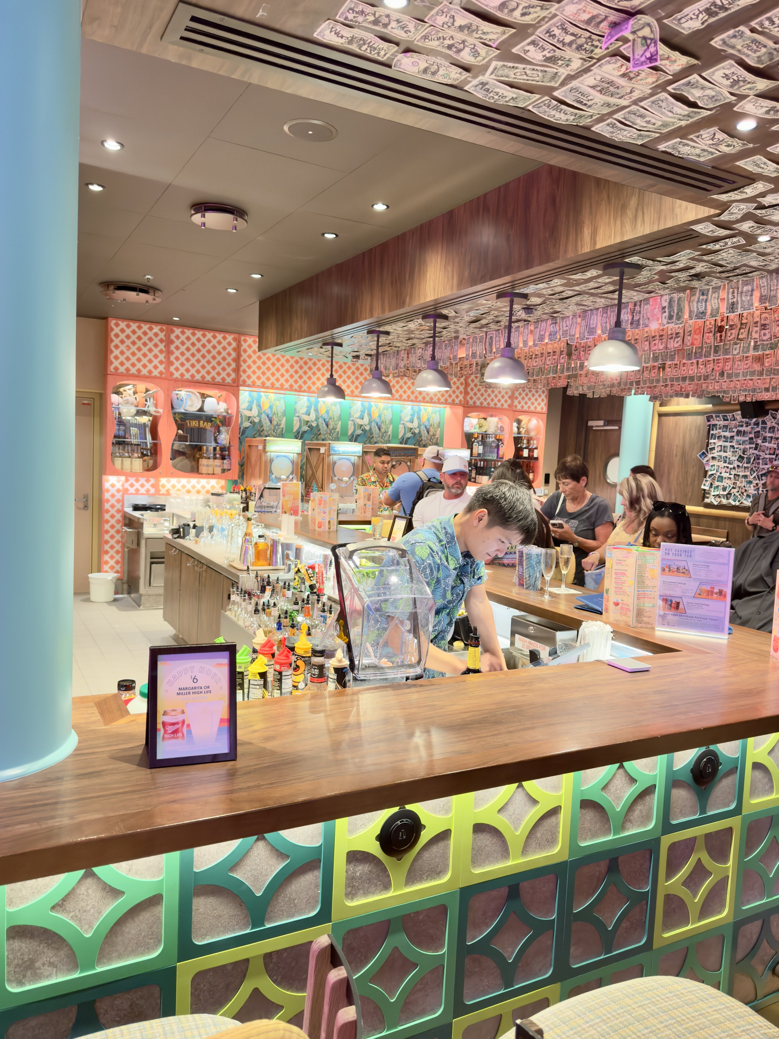 Colorful juice bar interior with staff preparing beverages for cruise guests