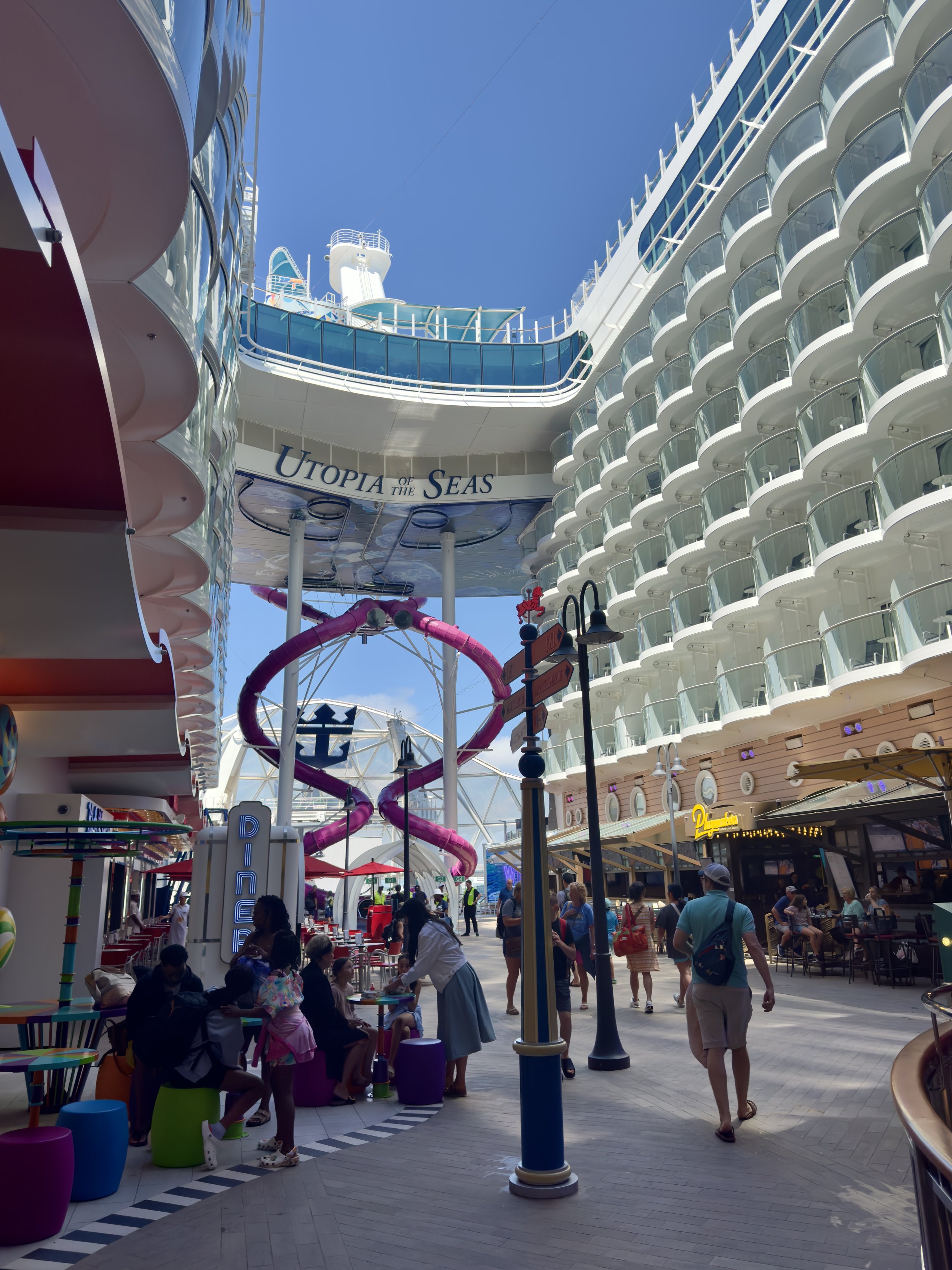 Utopia of the Seas cruise ship promenade with purple slide attraction