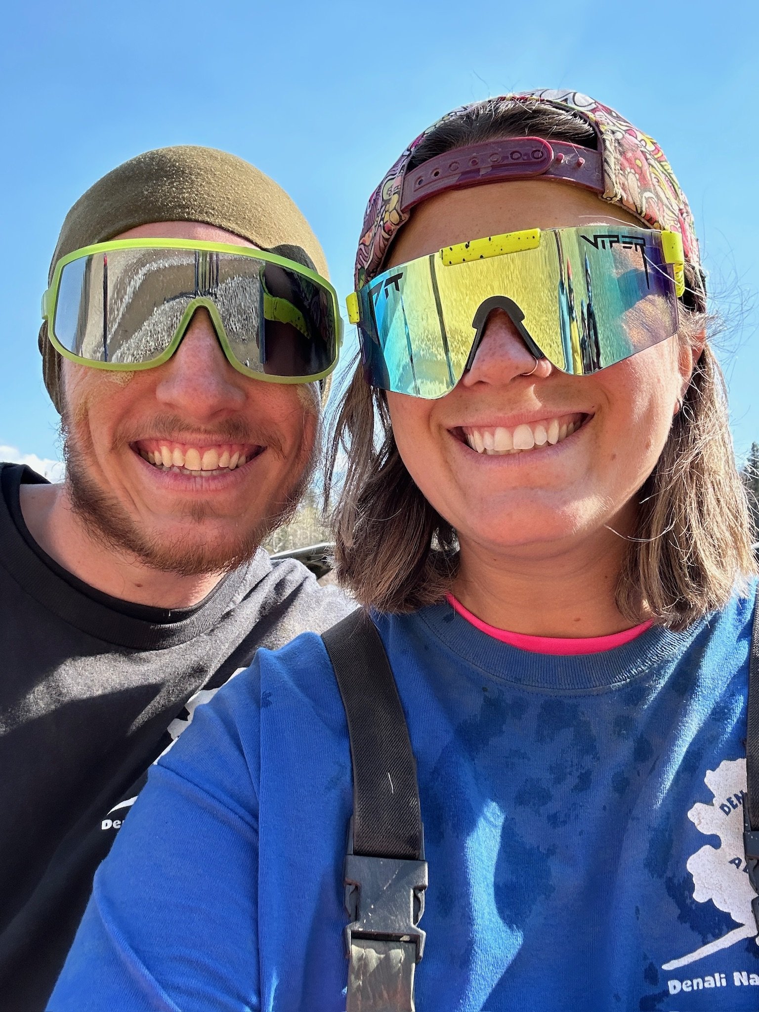 Two happy travelers wearing sunglasses on sunny cruise deck day