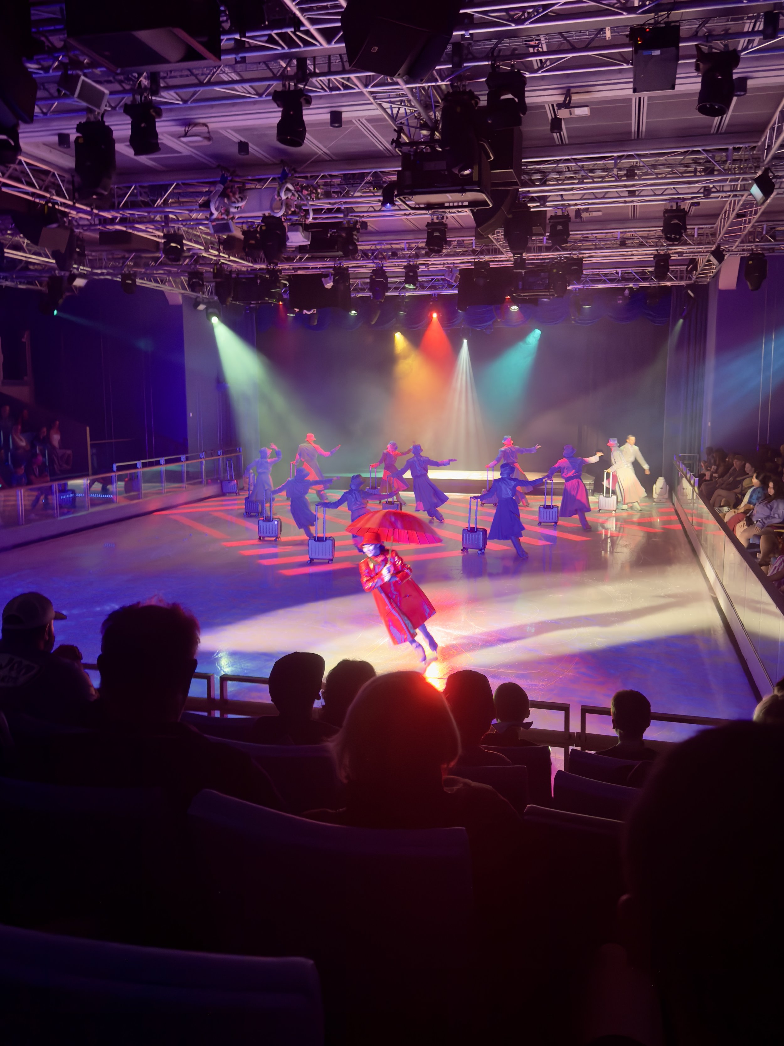 Professional ice skating show performance on cruise ship stage