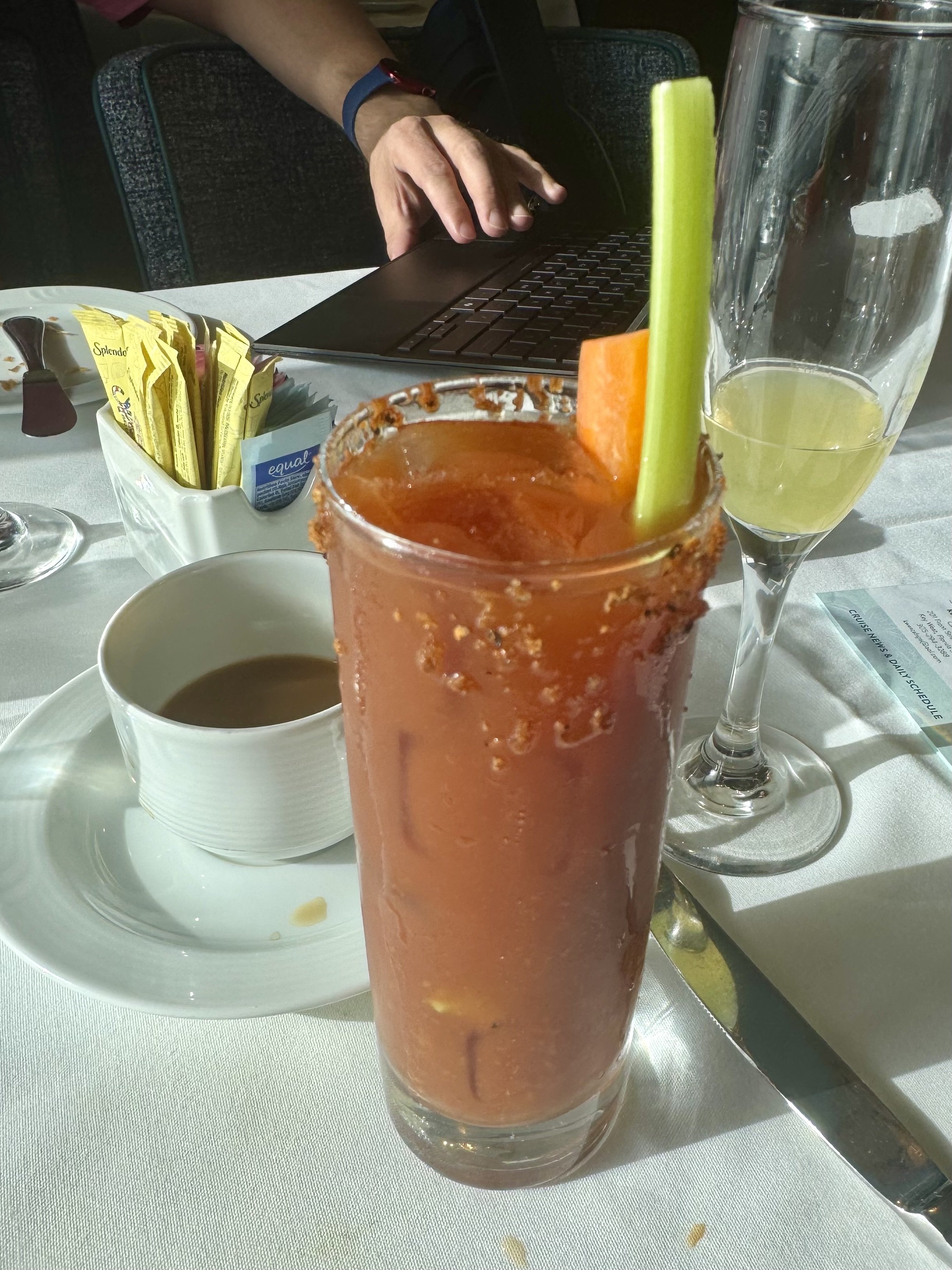 Bloody Mary cocktail with celery garnish at dining table