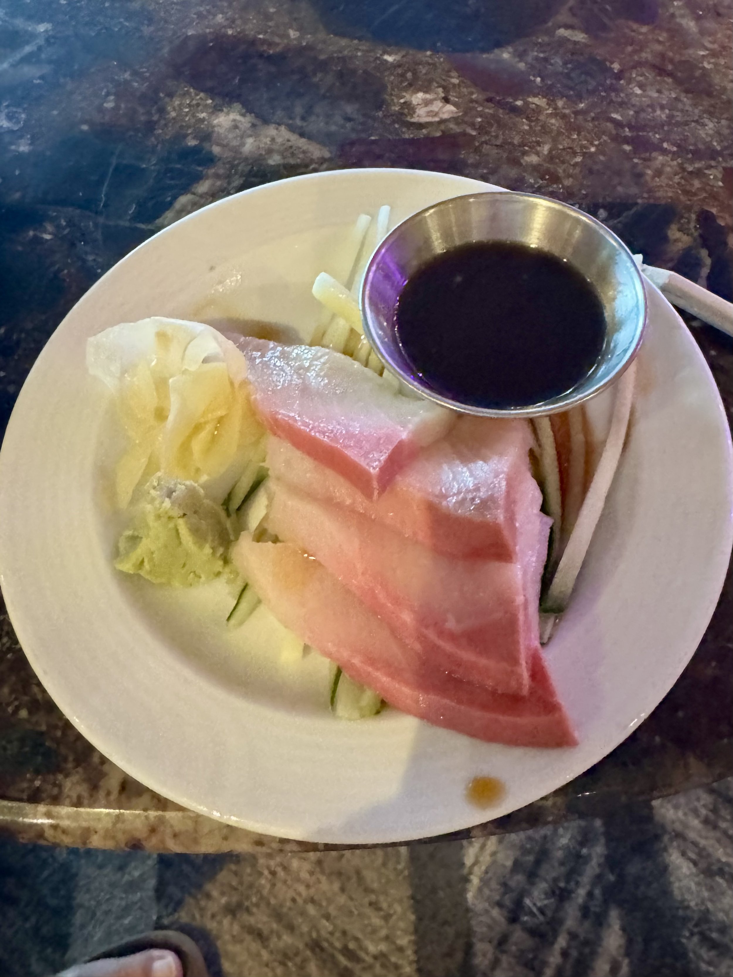 Sliced ham and cucumber with dipping sauce on cruise ship plate