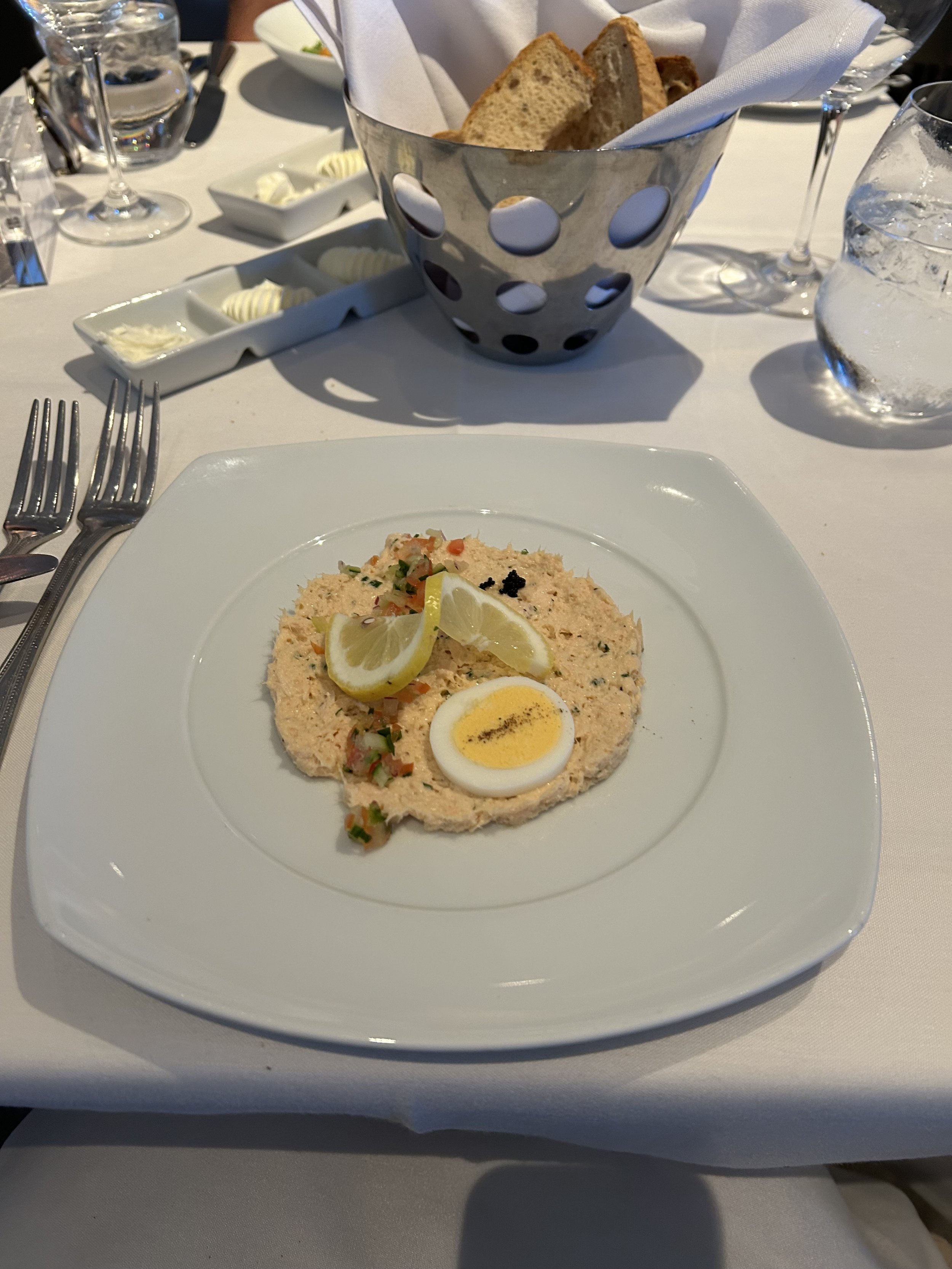 Elegant plated pâté appetizer with boiled egg and lemon garnish