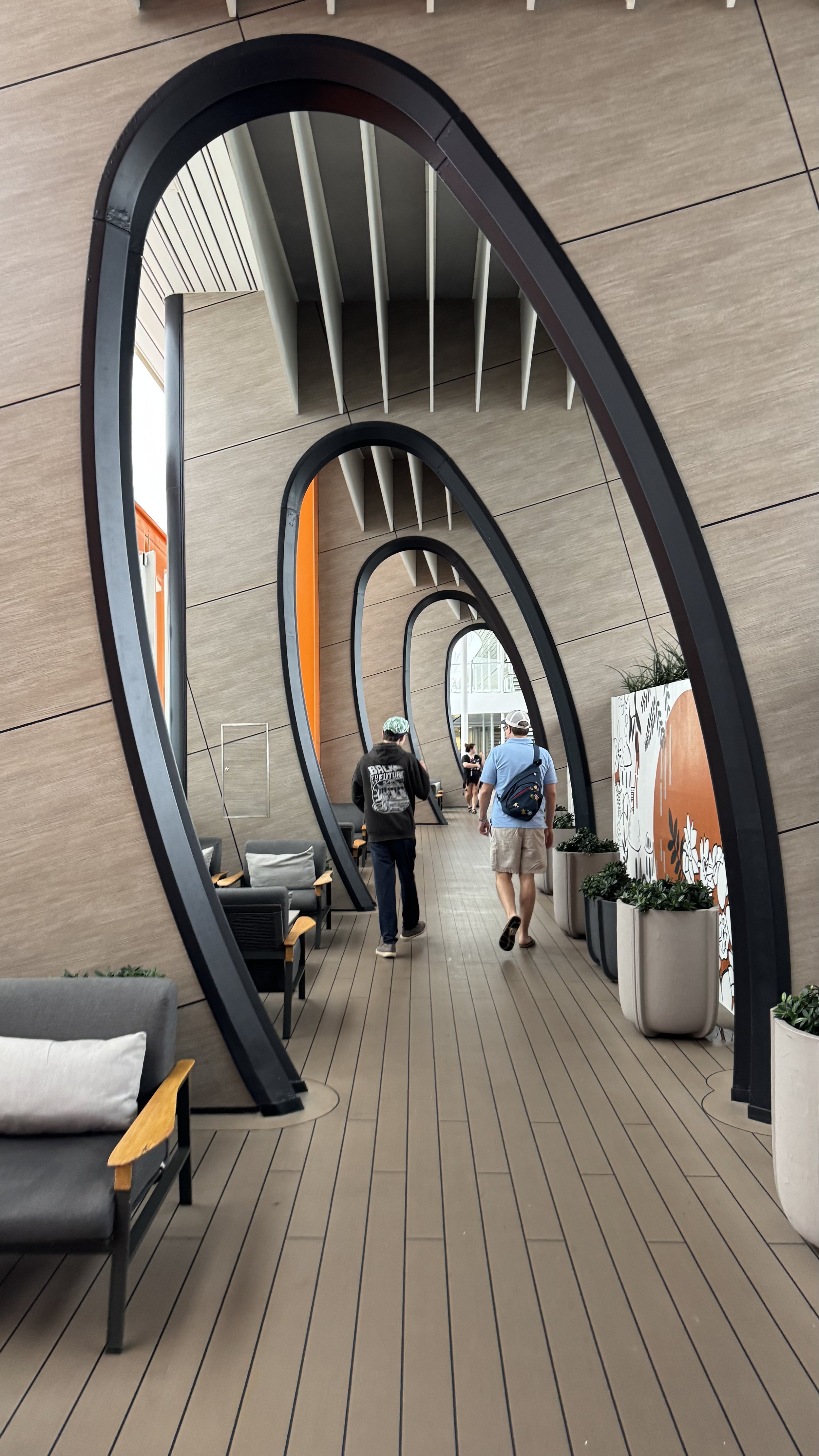 Modern cruise ship atrium with nested oval archways and deck