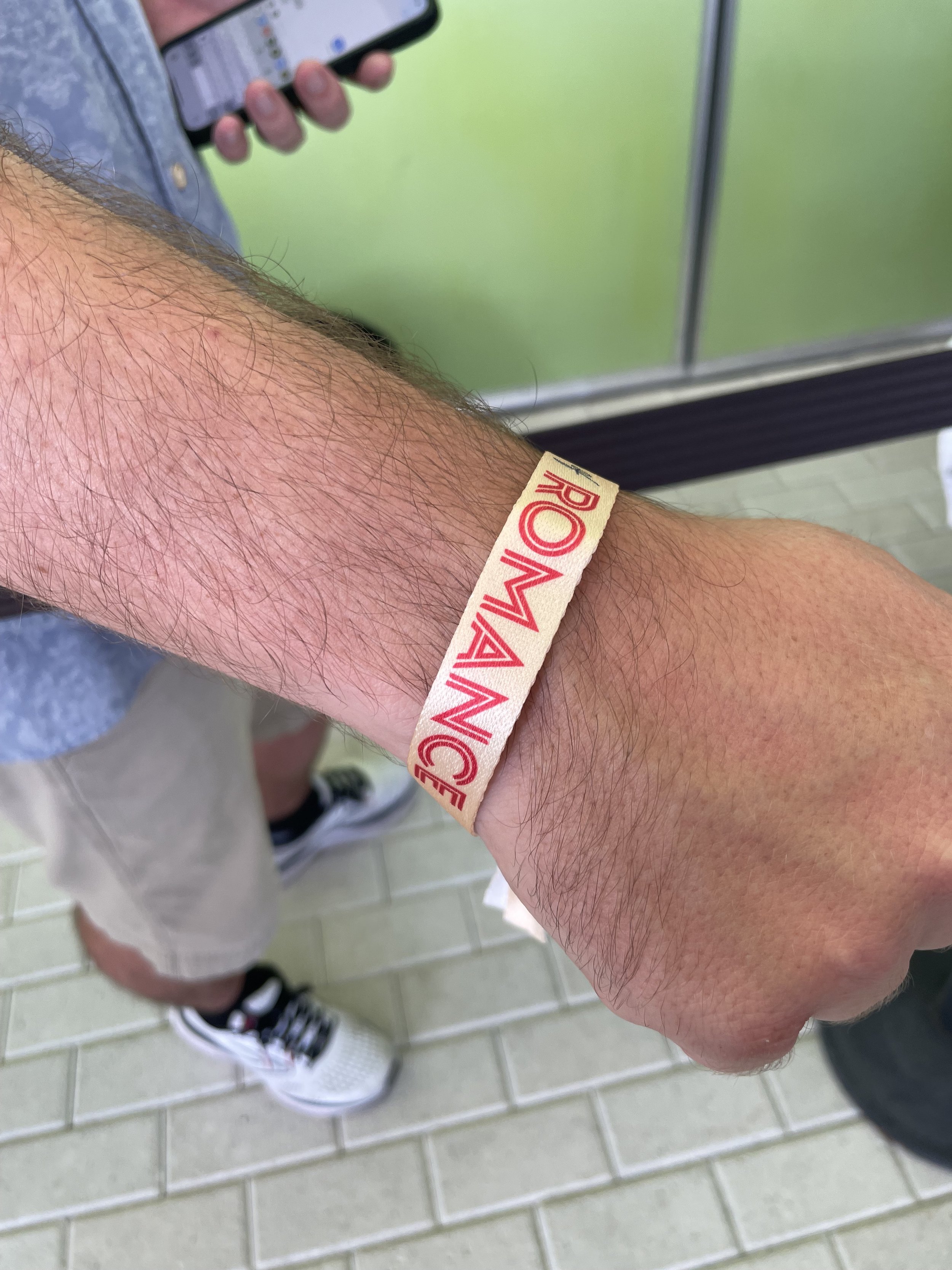 Man wearing red and white wristband on cruise ship