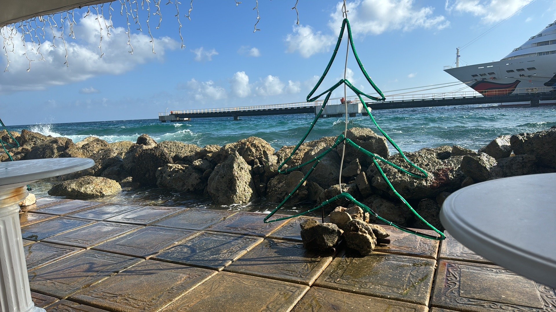 Rocky beach setup with cruise ship docked offshore