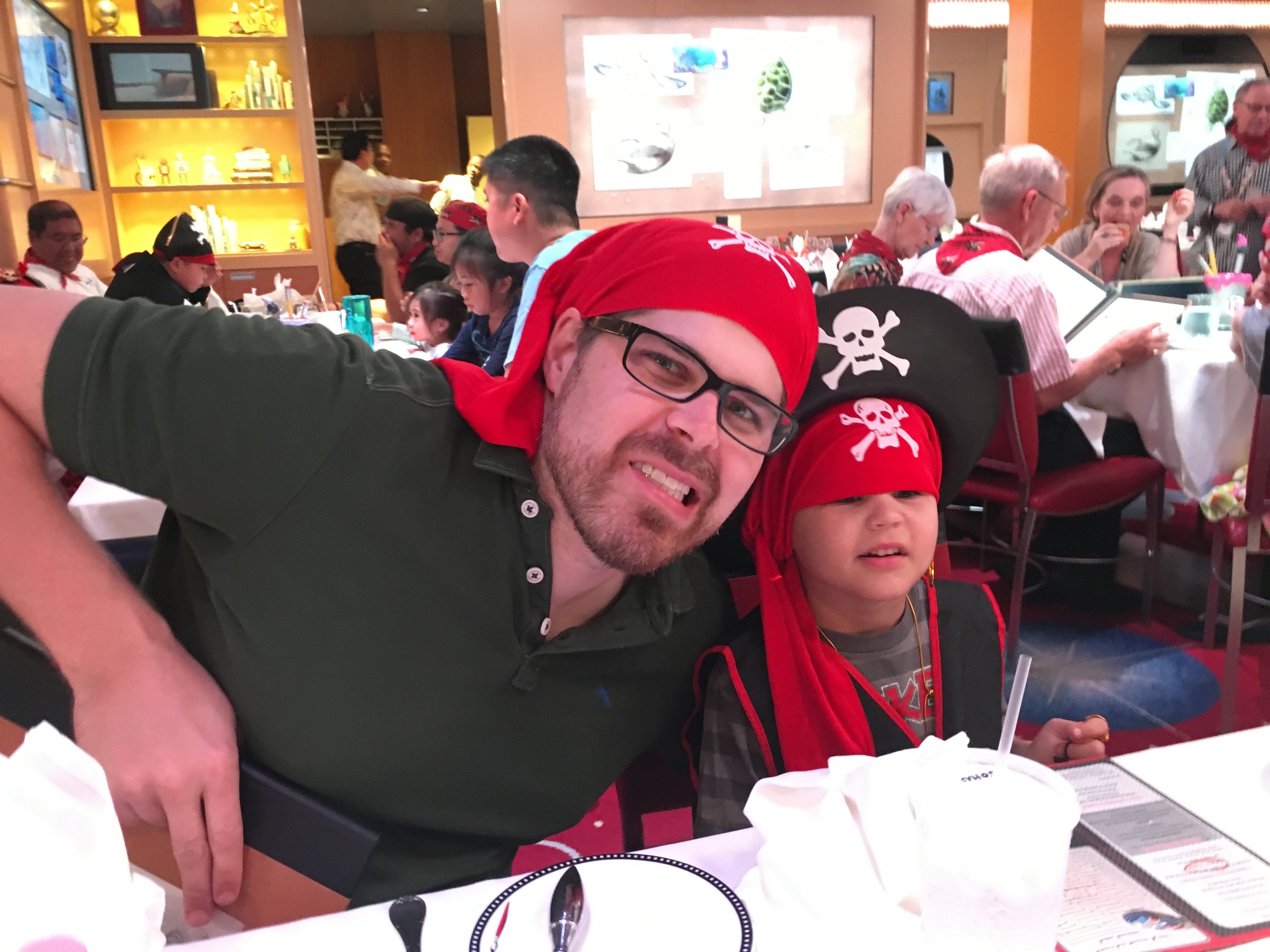 Man and child wearing pirate bandanas at themed dinner event