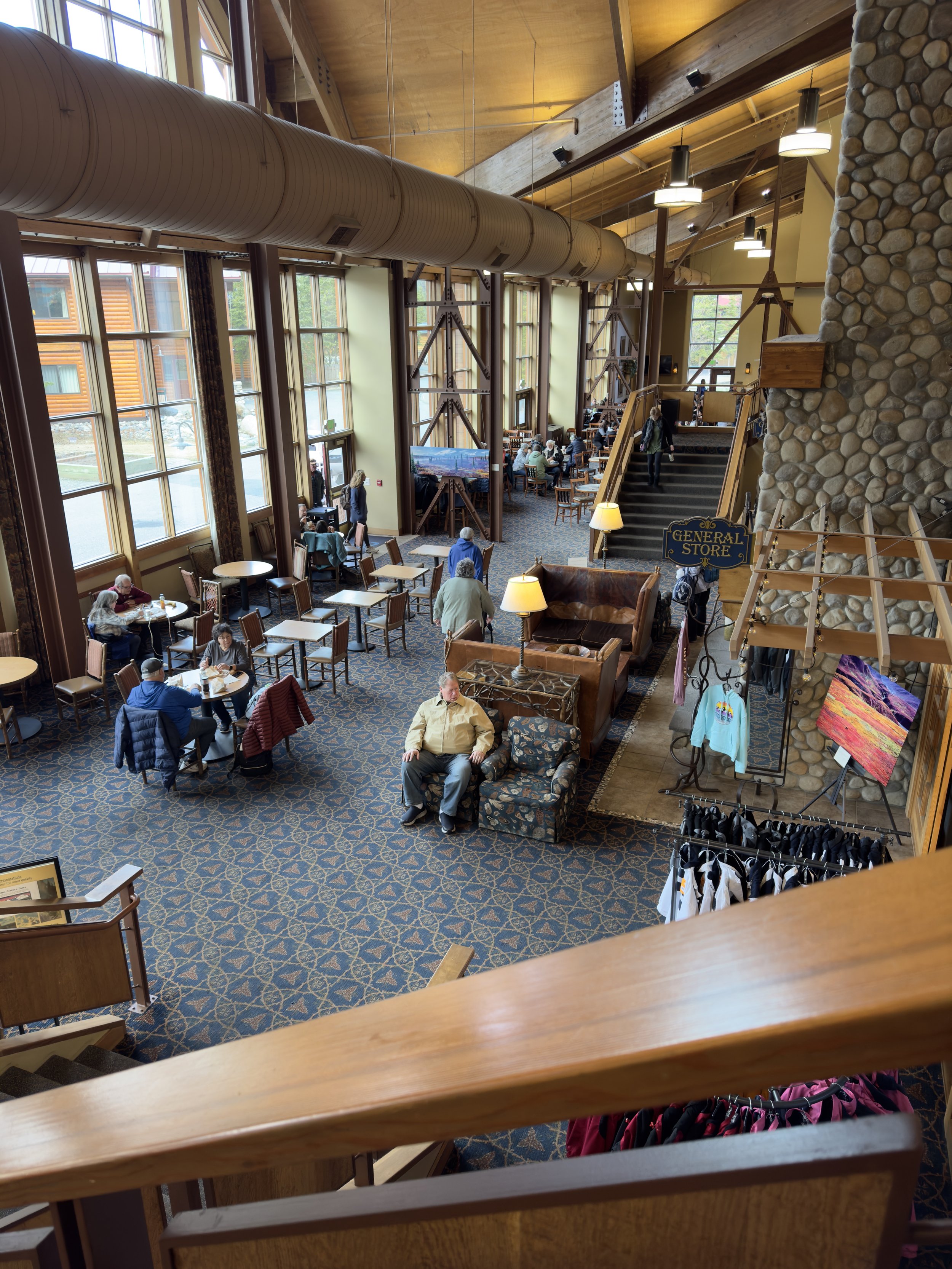 Large ship atrium with guests dining and shopping interior