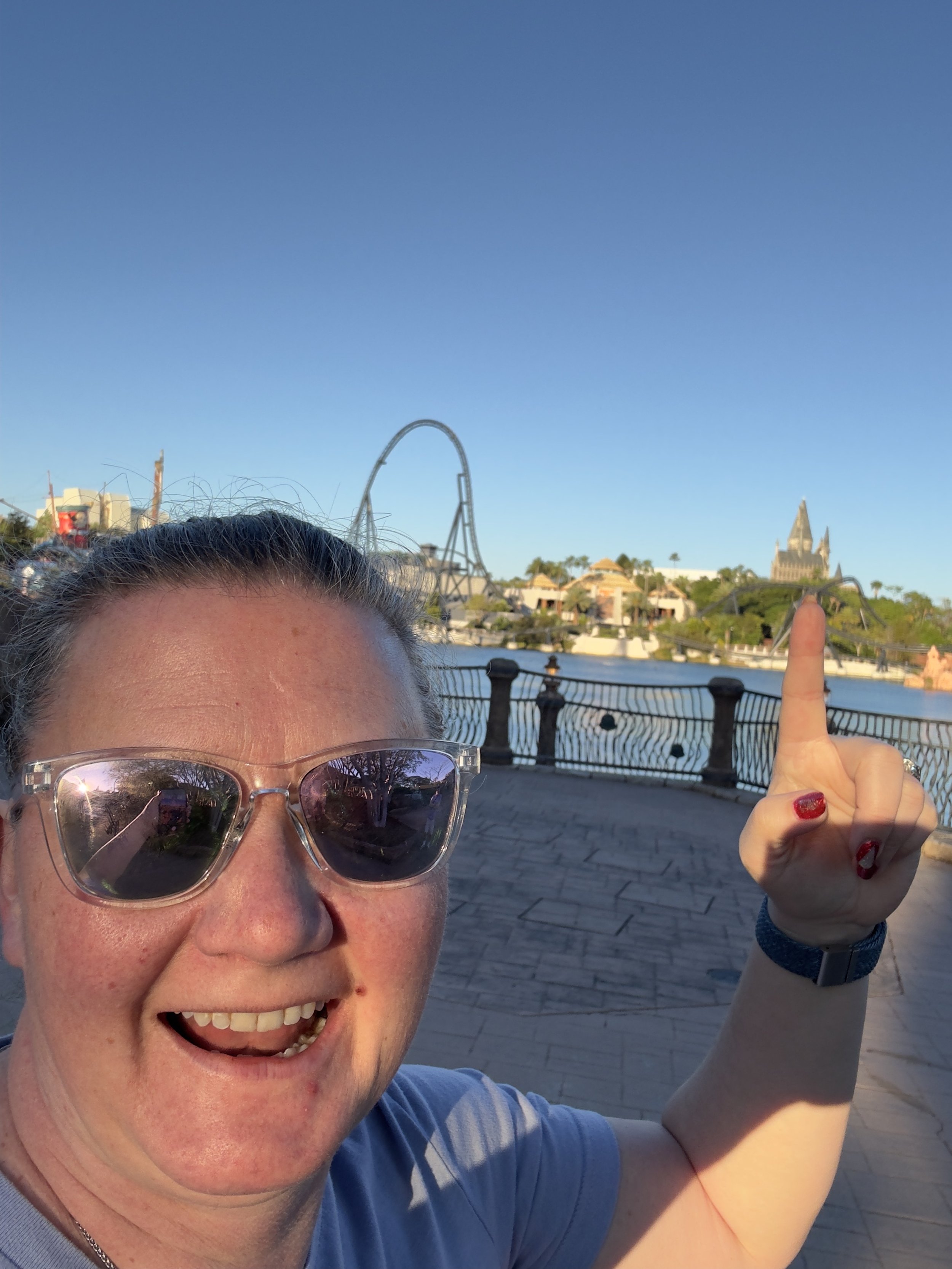 Woman at Universal Orlando theme park with roller coaster