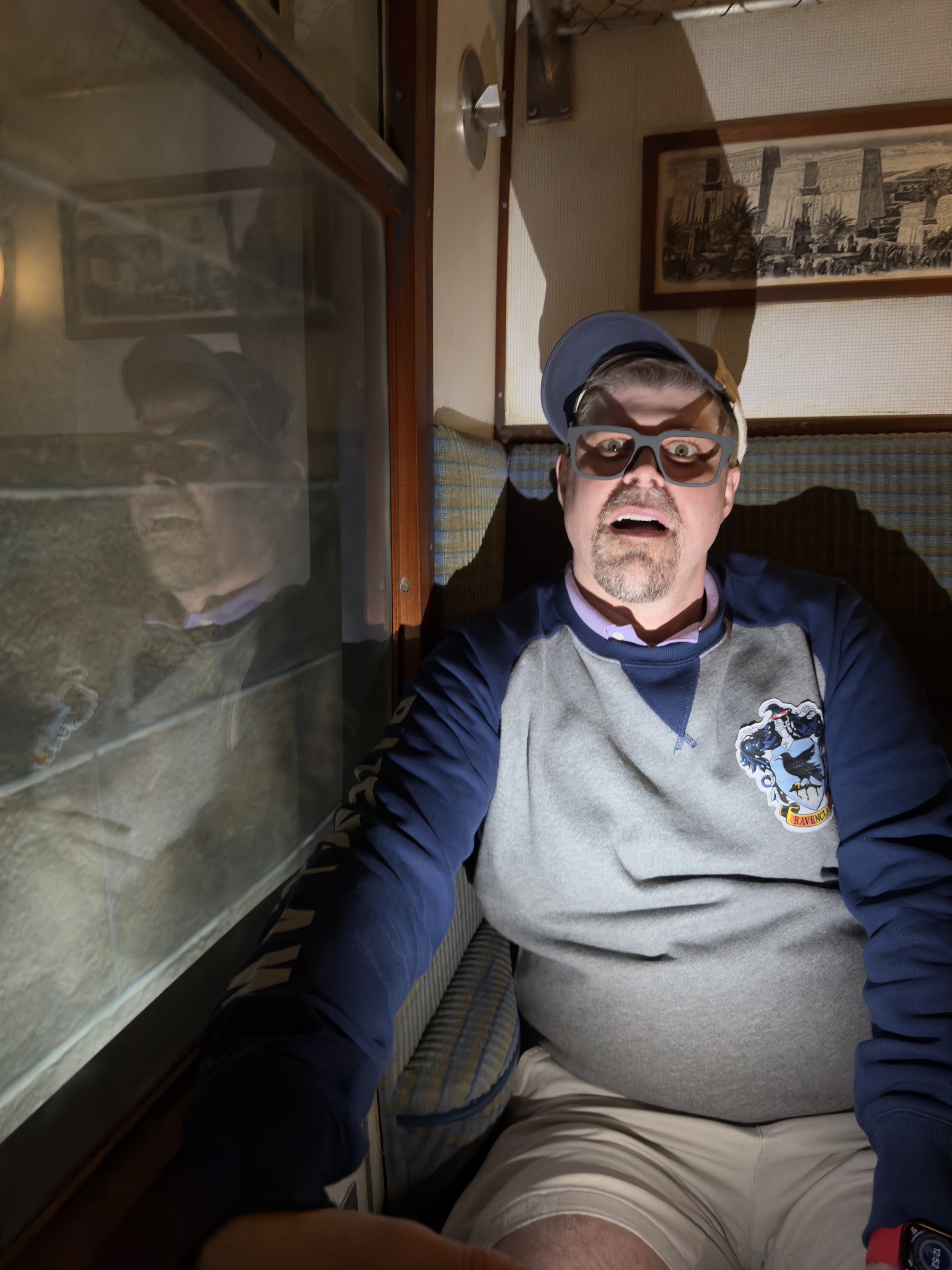 Man enjoying cruise ship interior cabin window view