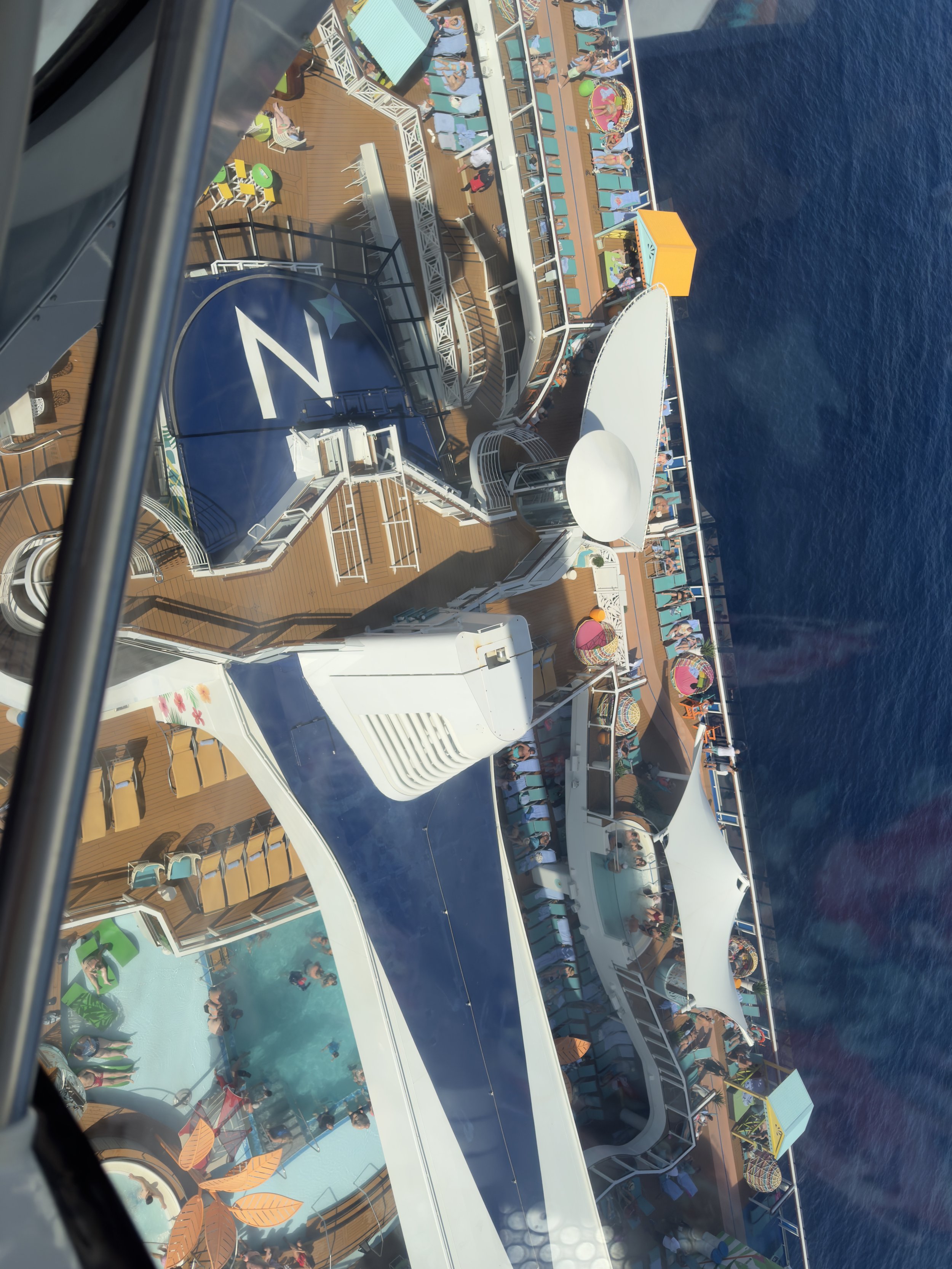 Aerial view of cruise ship deck with pools and passengers