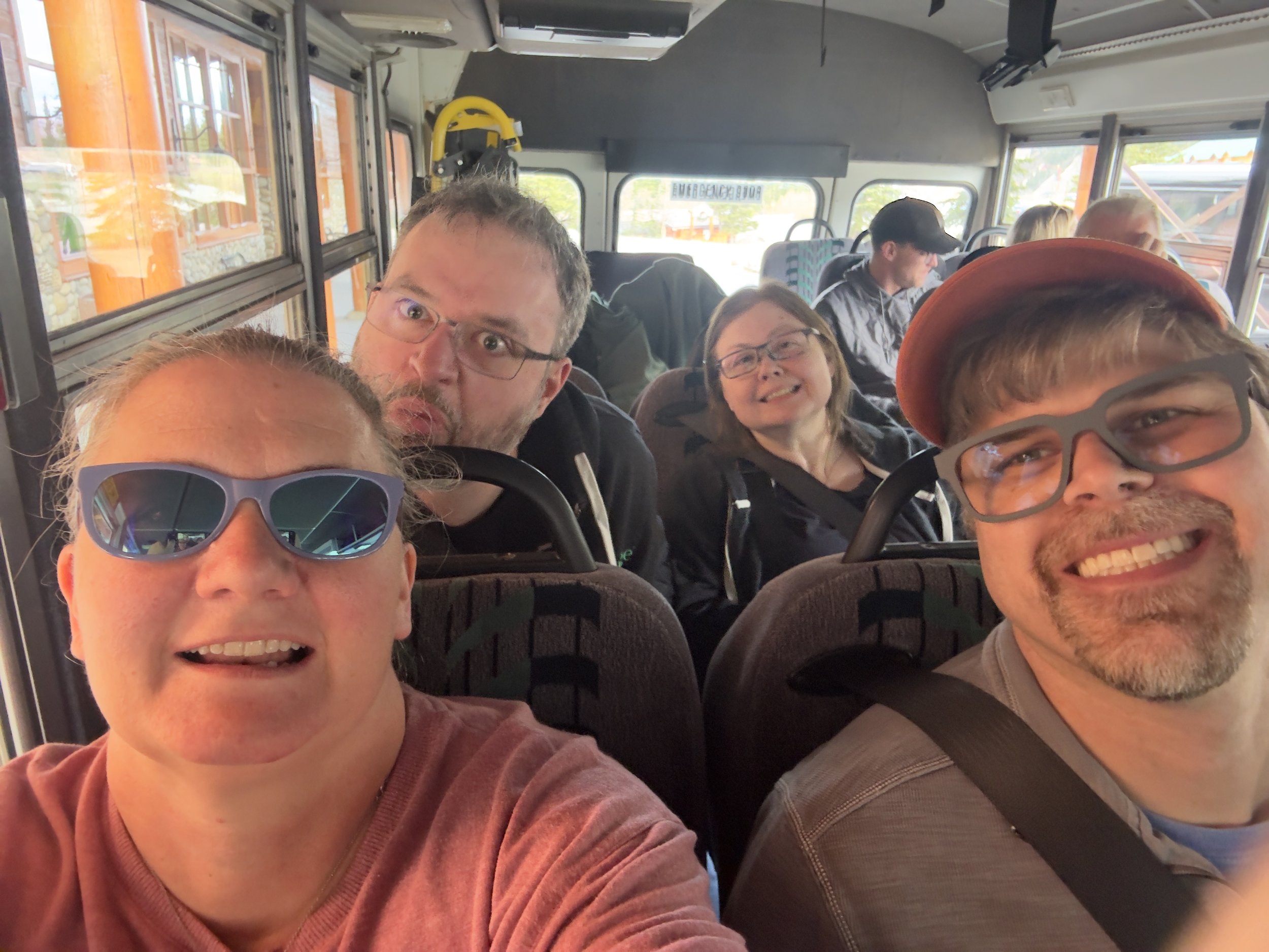 Group of passengers smiling on tour bus during cruise excursion