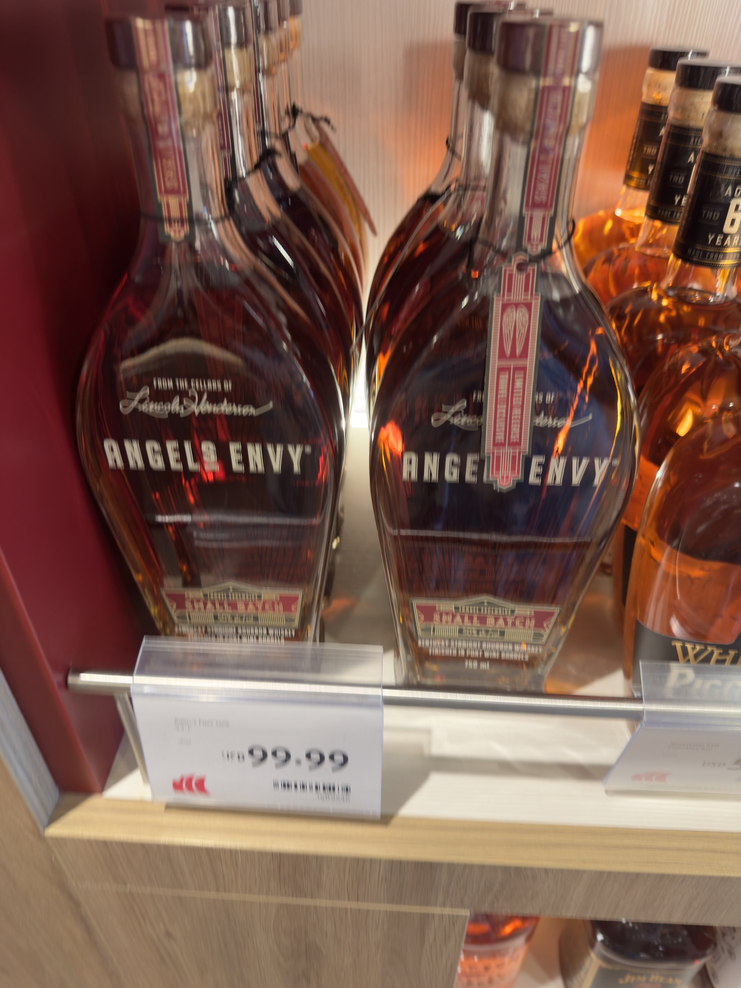 Angel's Envy bourbon bottles displayed in liquor store shelf