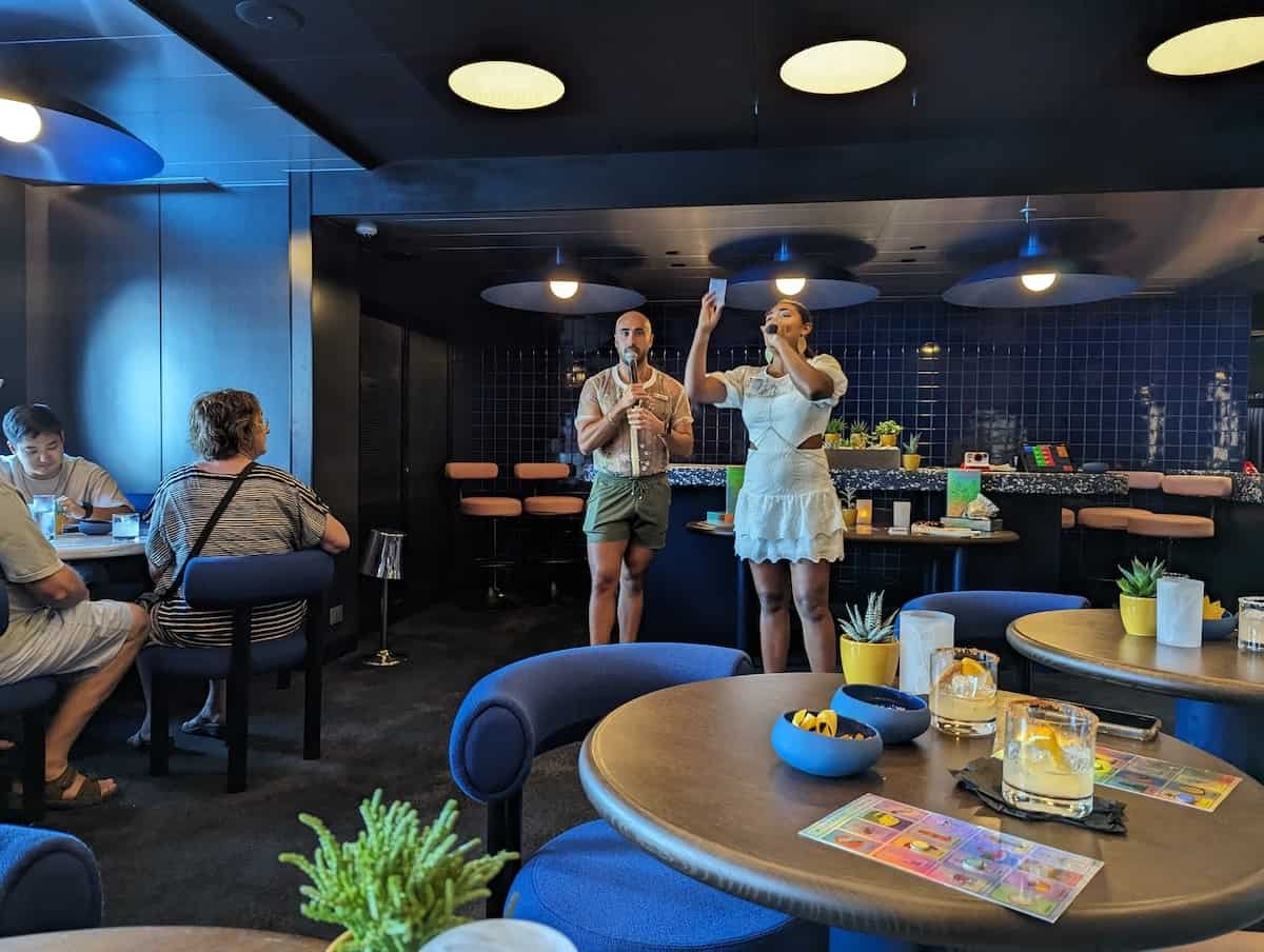 Modern cruise ship lounge with guests enjoying karaoke entertainment activity